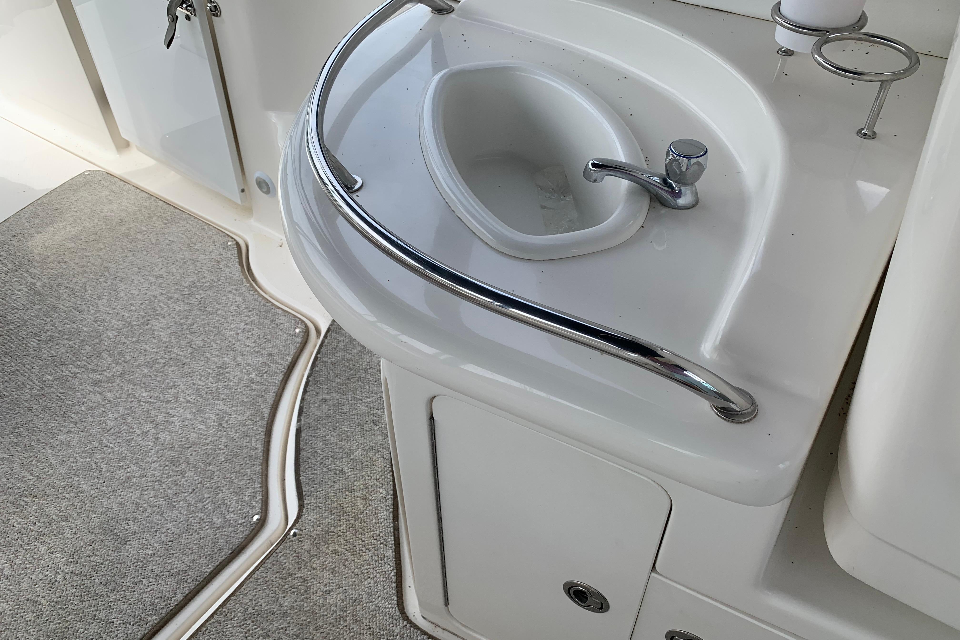 2007 Sea Ray 340 Sundancer boat sink with chrome faucet and railing.