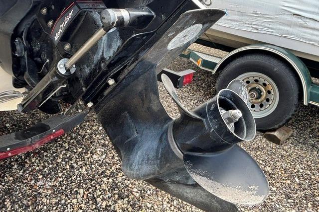 2021 Chaparral 21 SSi boat propeller and trailer on gravel surface.