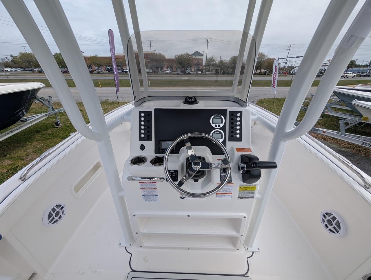 2025 Robalo R222 Explorer boat cockpit with steering wheel and control panel.