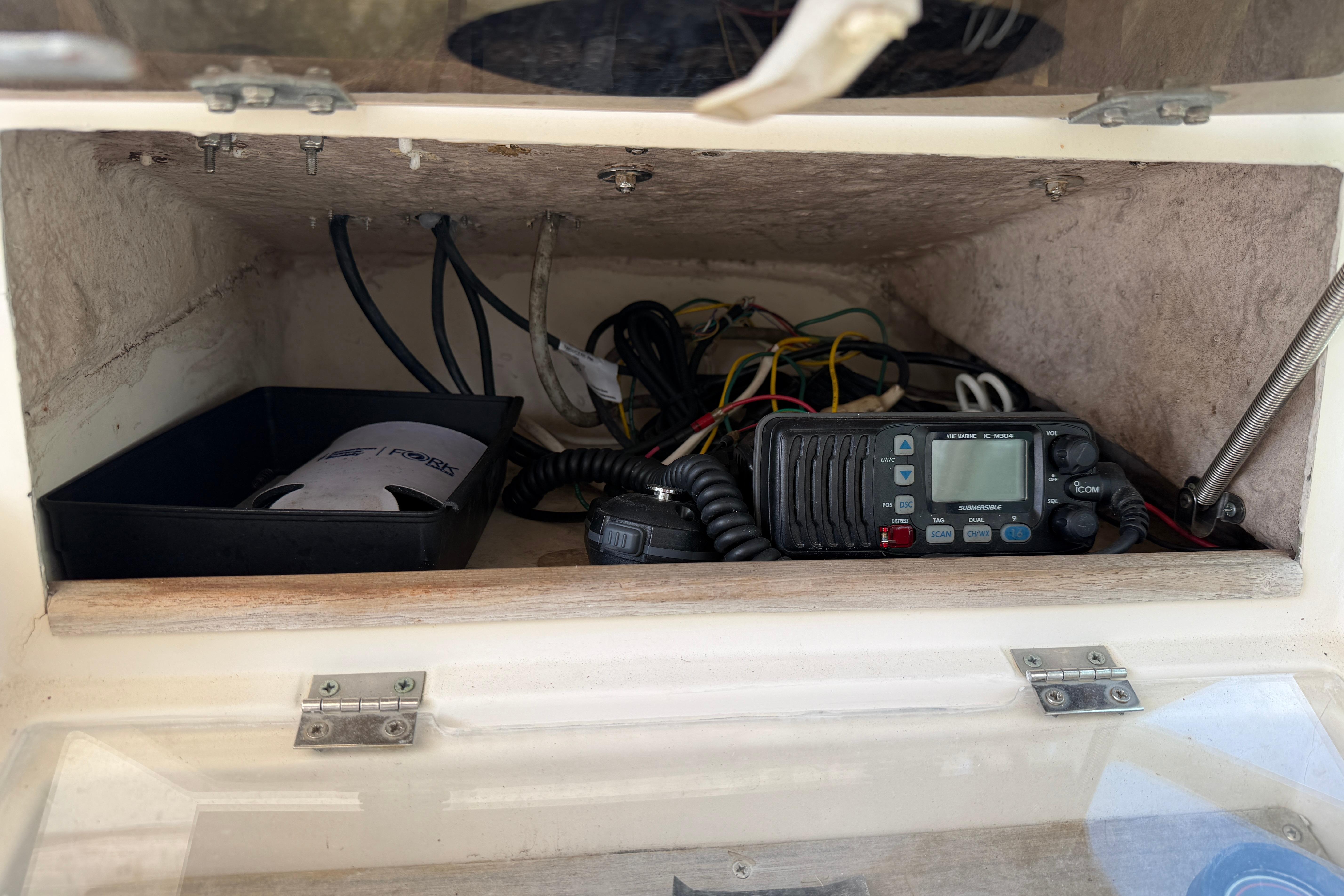 1987 Grady-White Seafarer 226 boat electronics compartment with radio and wiring.