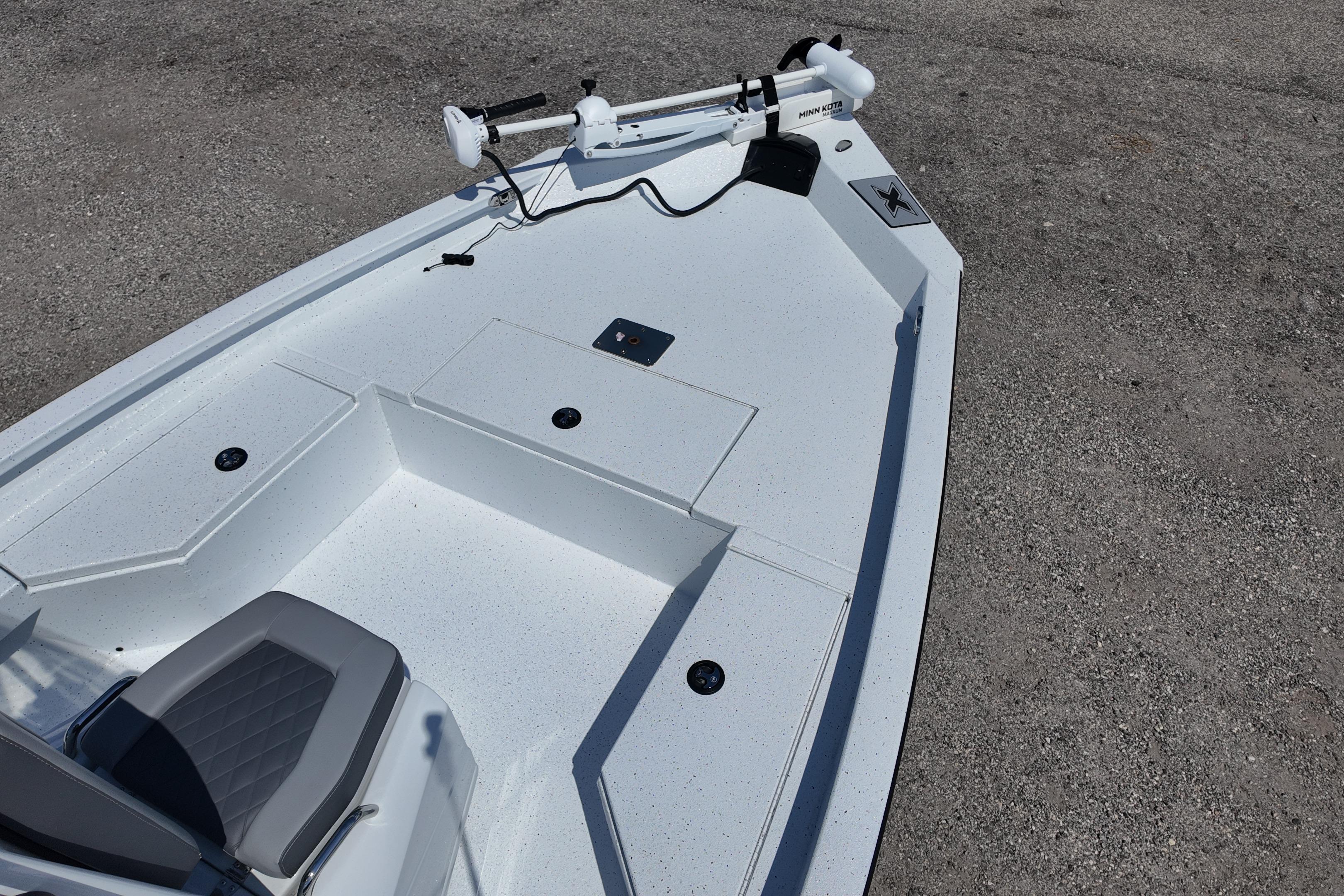 2026 Xpress H20 boat deck with seating and trolling motor, parked on concrete surface.