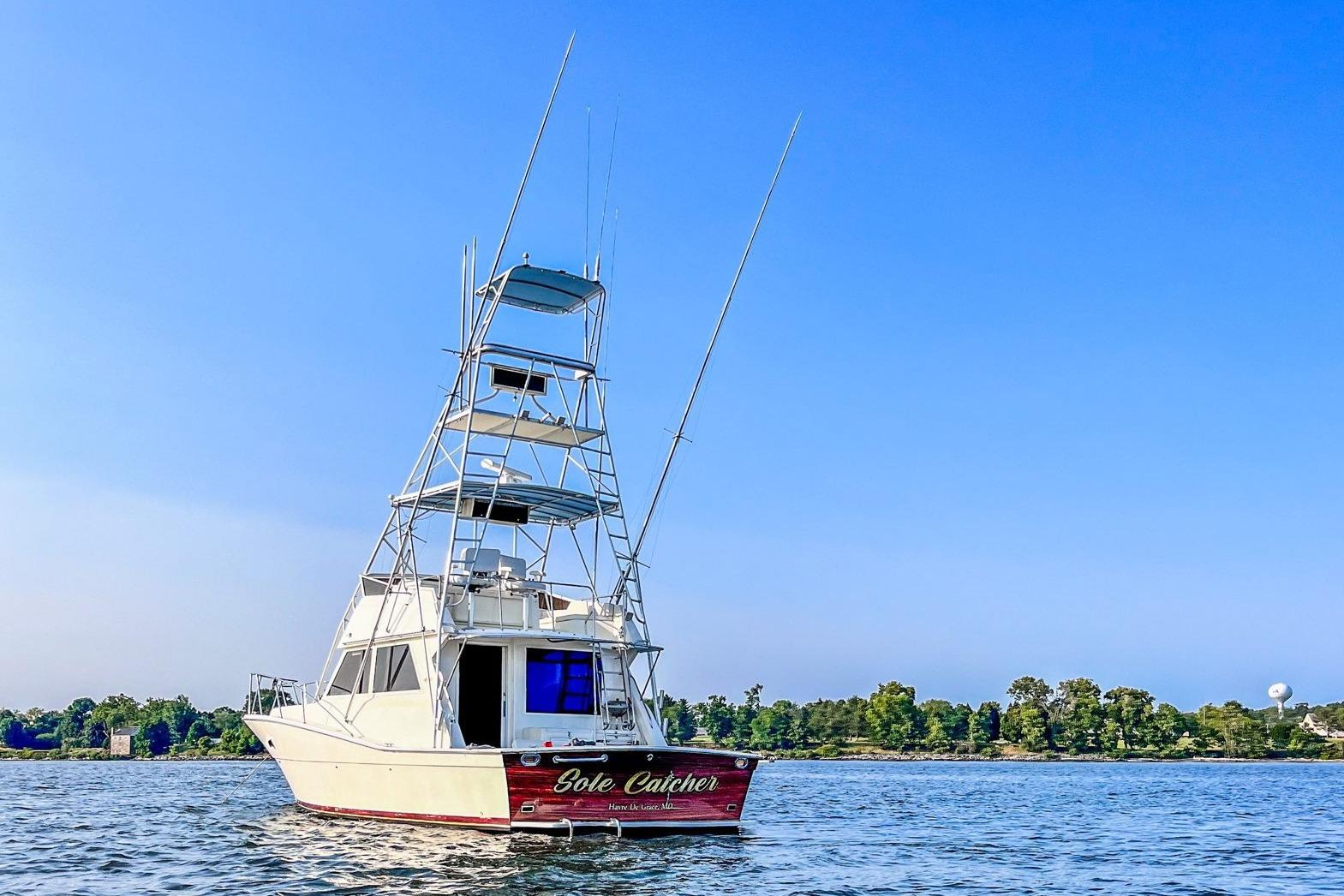 1986 Viking Sportfish 41 boat on water under clear blue sky.
