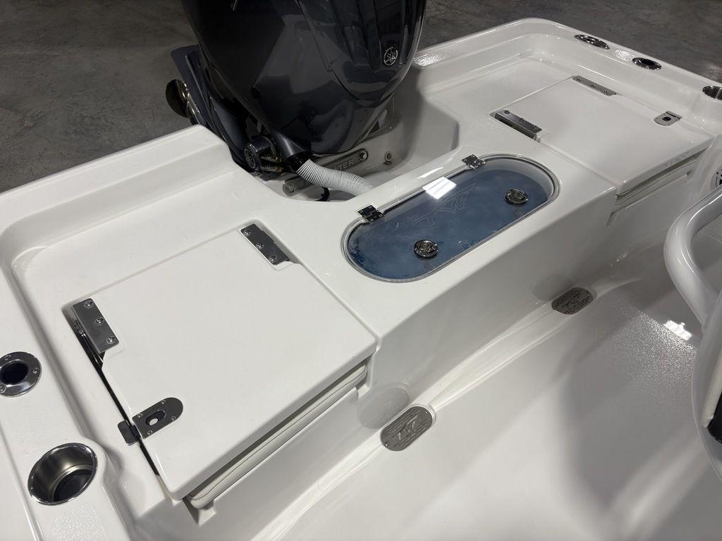 2026 Tidewater 2110 BM boat interior with storage compartments and motor.