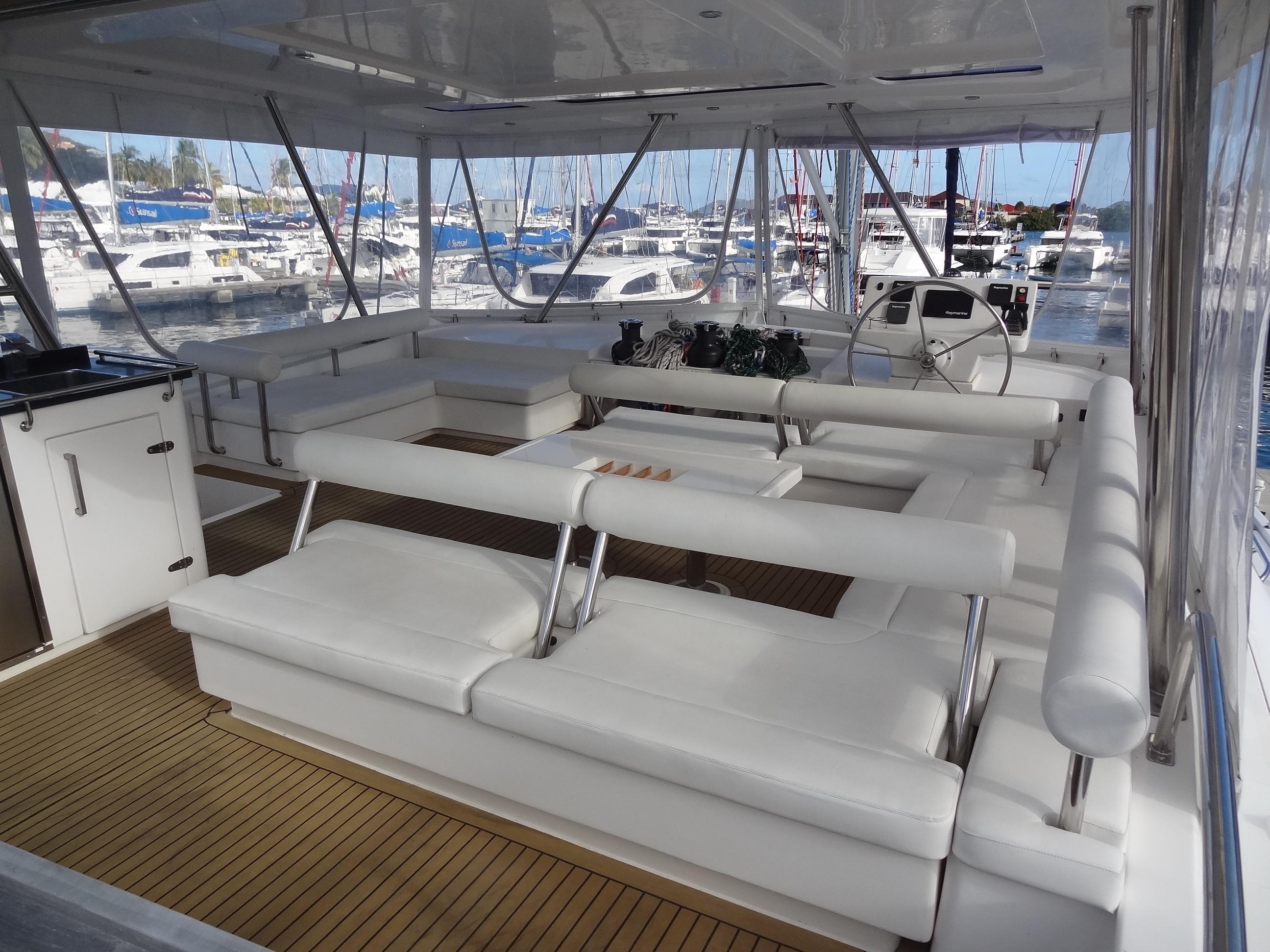 Luxurious 2014 Leopard 58 yacht interior with white seating and marina view.