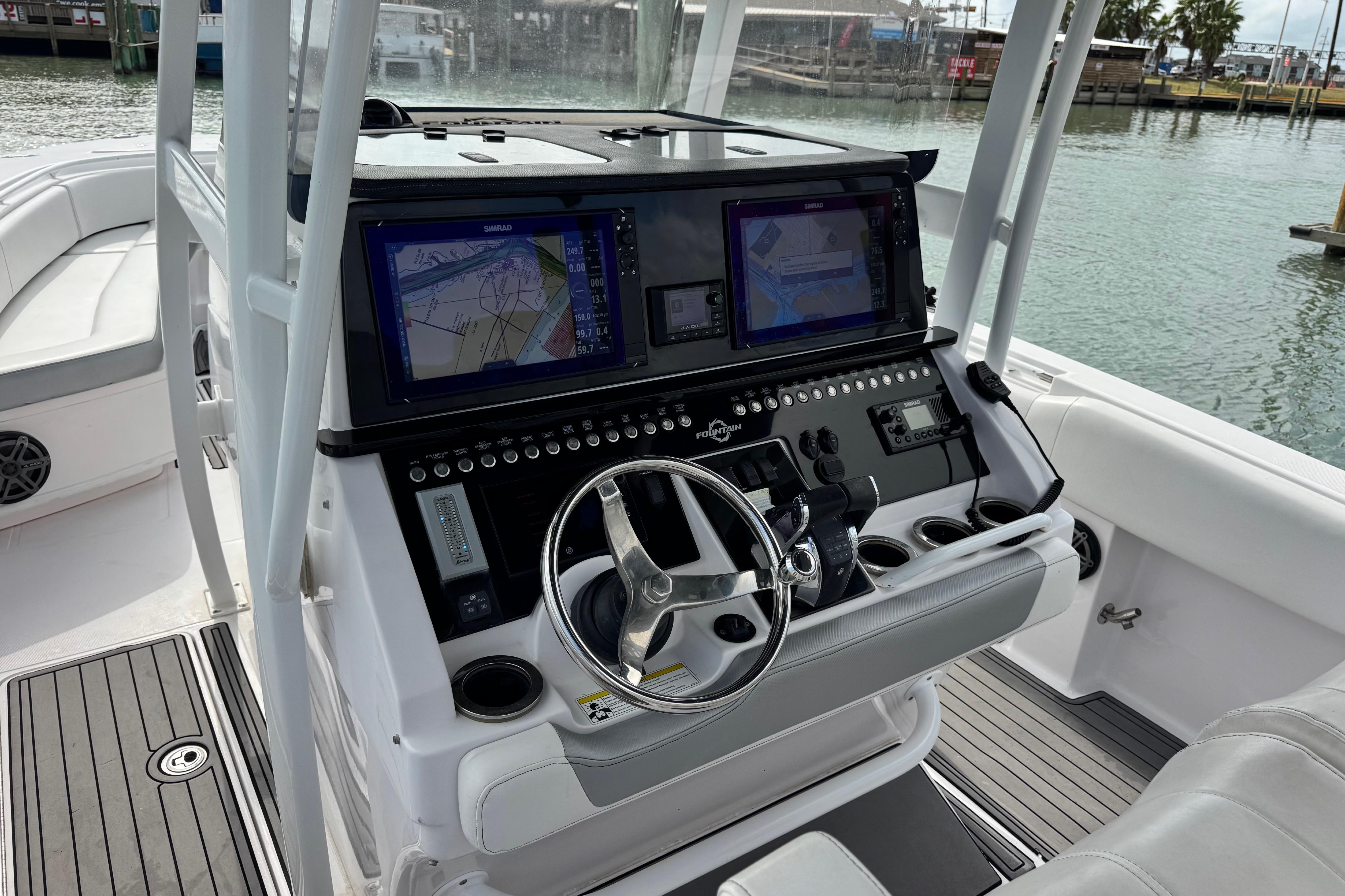 2018 Fountain 34 Center Console boat with advanced navigation system and sleek steering wheel.