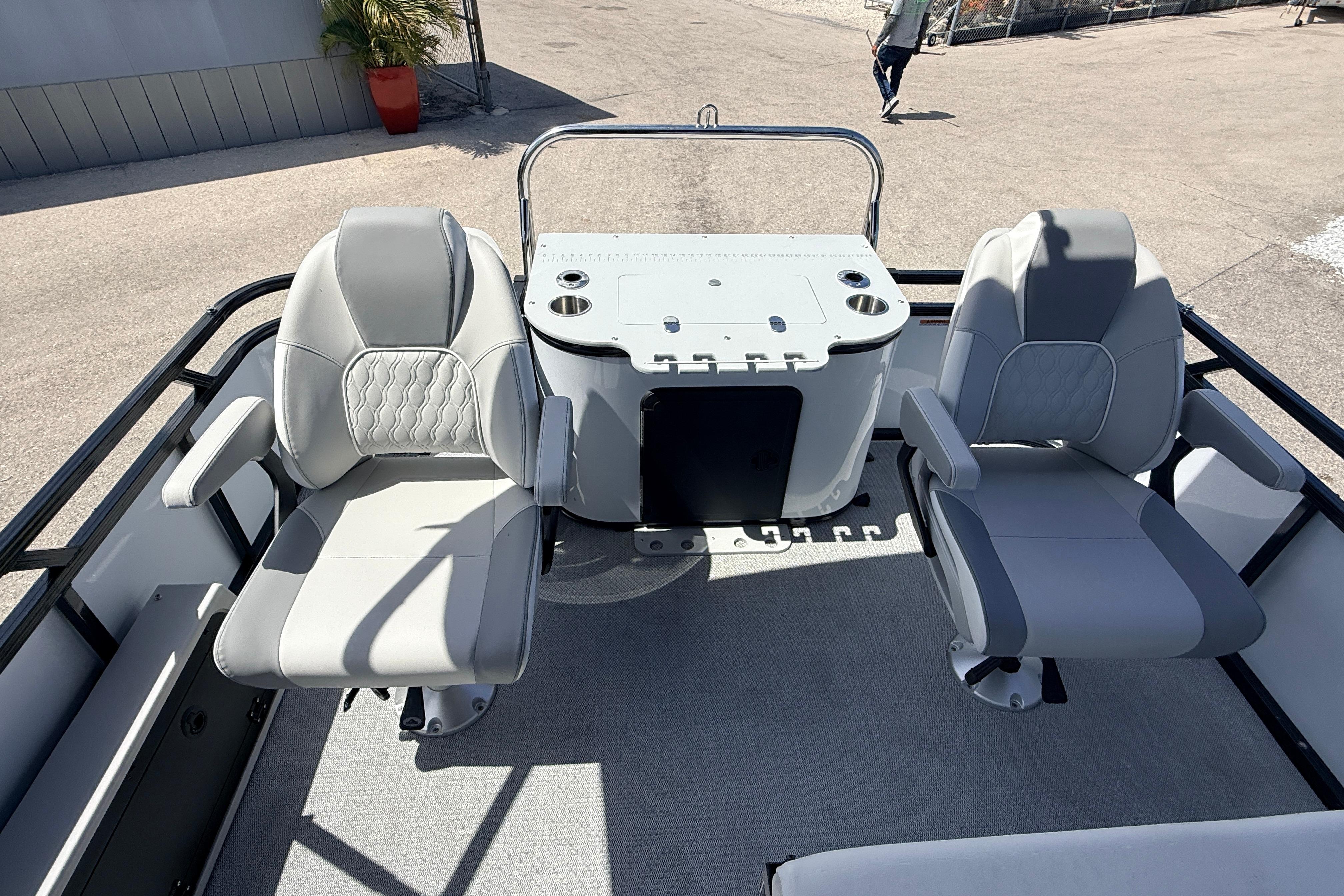 2026 Avalon 2385 Venture 85 Tri Toon boat interior with two swivel seats and fishing station.