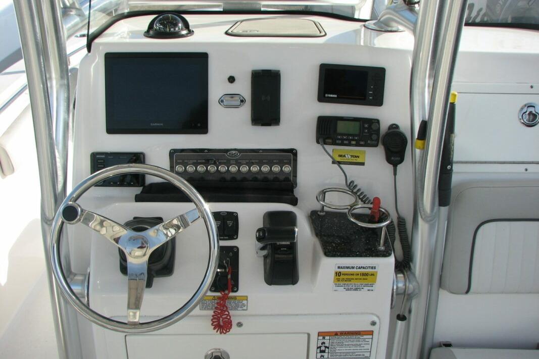 Control panel of a 2020 Sea Fox 249 Avenger boat with steering wheel and electronics.