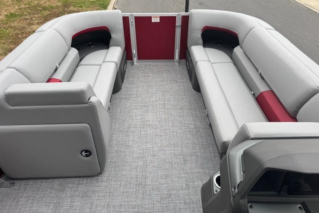 2026 Sun Tracker Party Barge 22 DLX interior with gray and red seating.