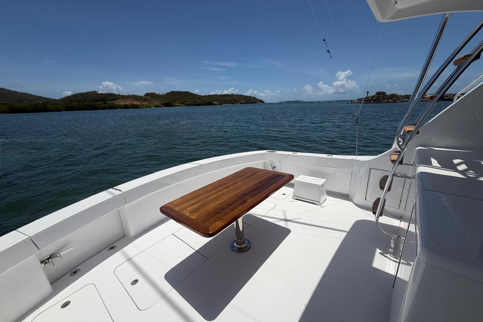 Spacious deck of 2003 Hatteras 54 Convertible yacht with ocean view.