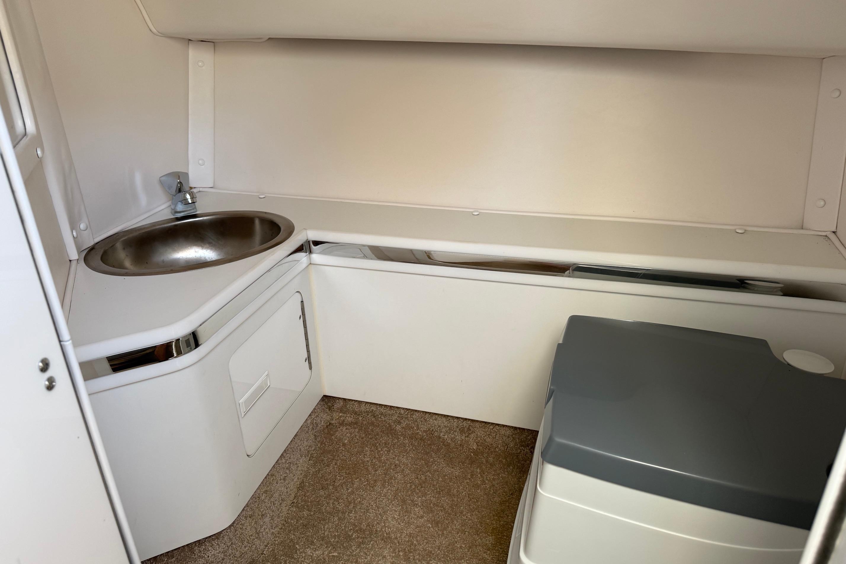 1998 Fountain 35 Lightning boat interior with sink and compact toilet.