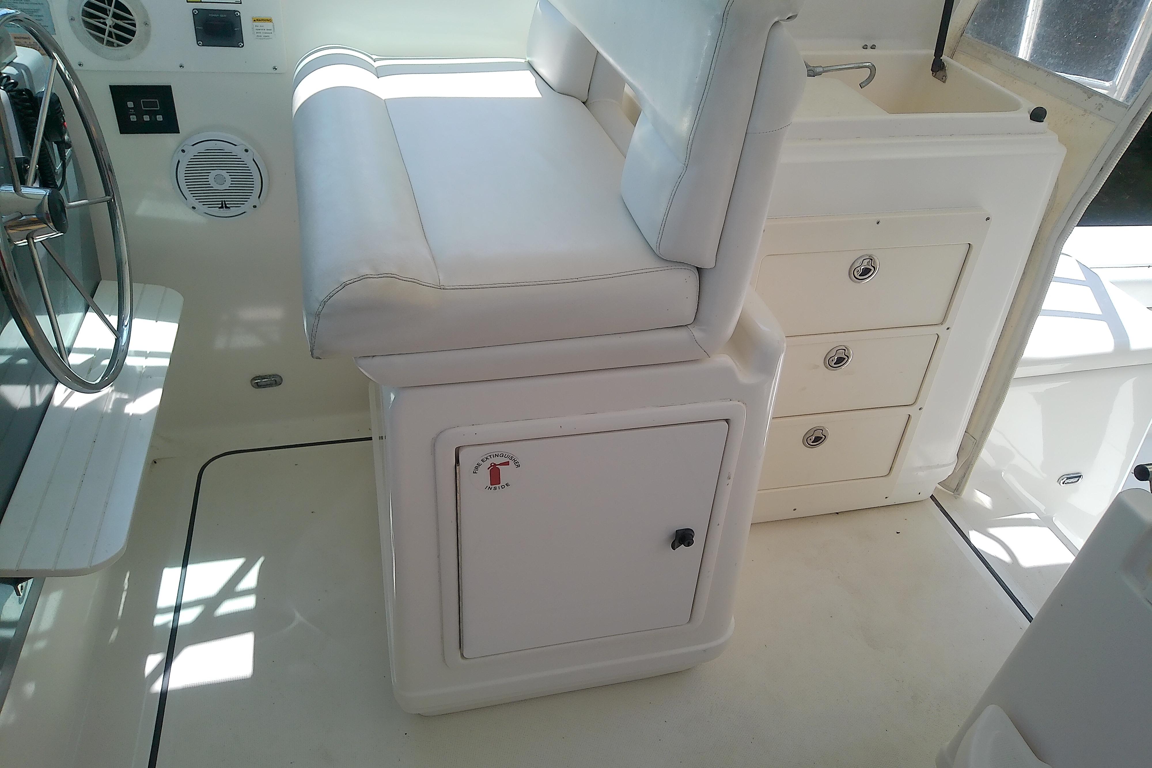 Interior of a 2000 Tiara Yachts 4100 Open, featuring helm seat and storage drawers.