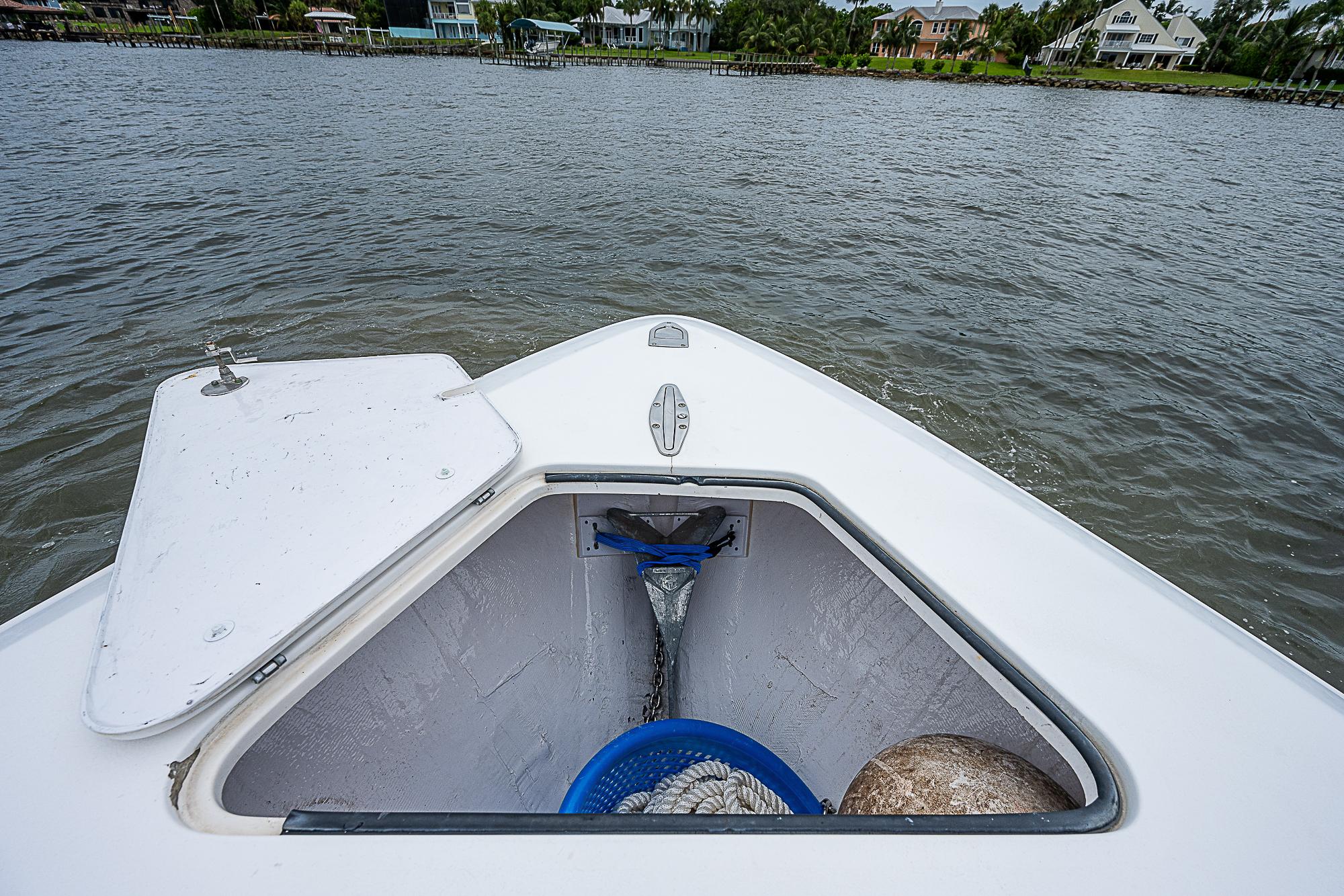 Open storage compartment on 2004 Contender 36 Open boat, view of water and shoreline.