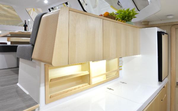 Modern kitchen interior of 2025 Seawind 1170 yacht with wooden cabinets and sleek design.