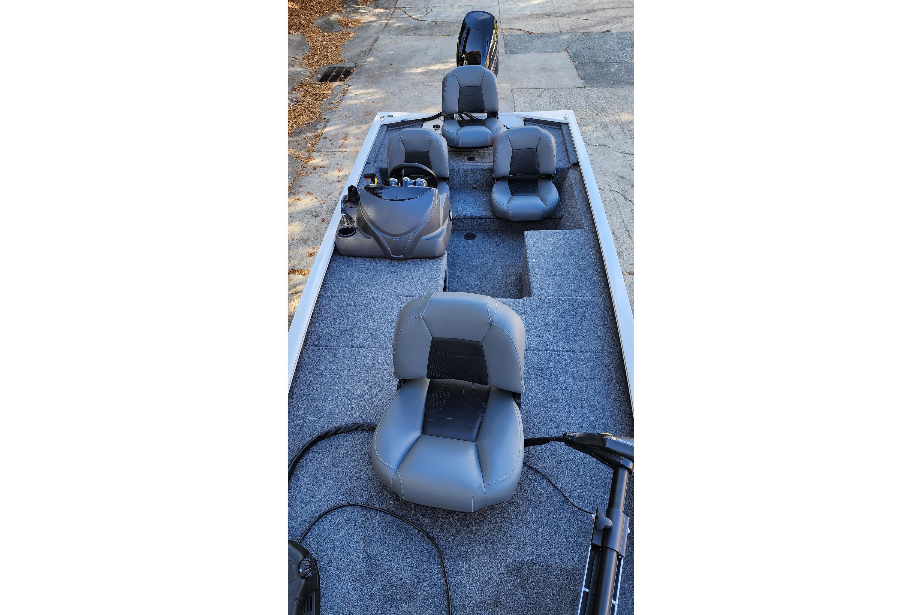 2026 Tracker Pro 170 boat interior with gray seating and carpeted deck.