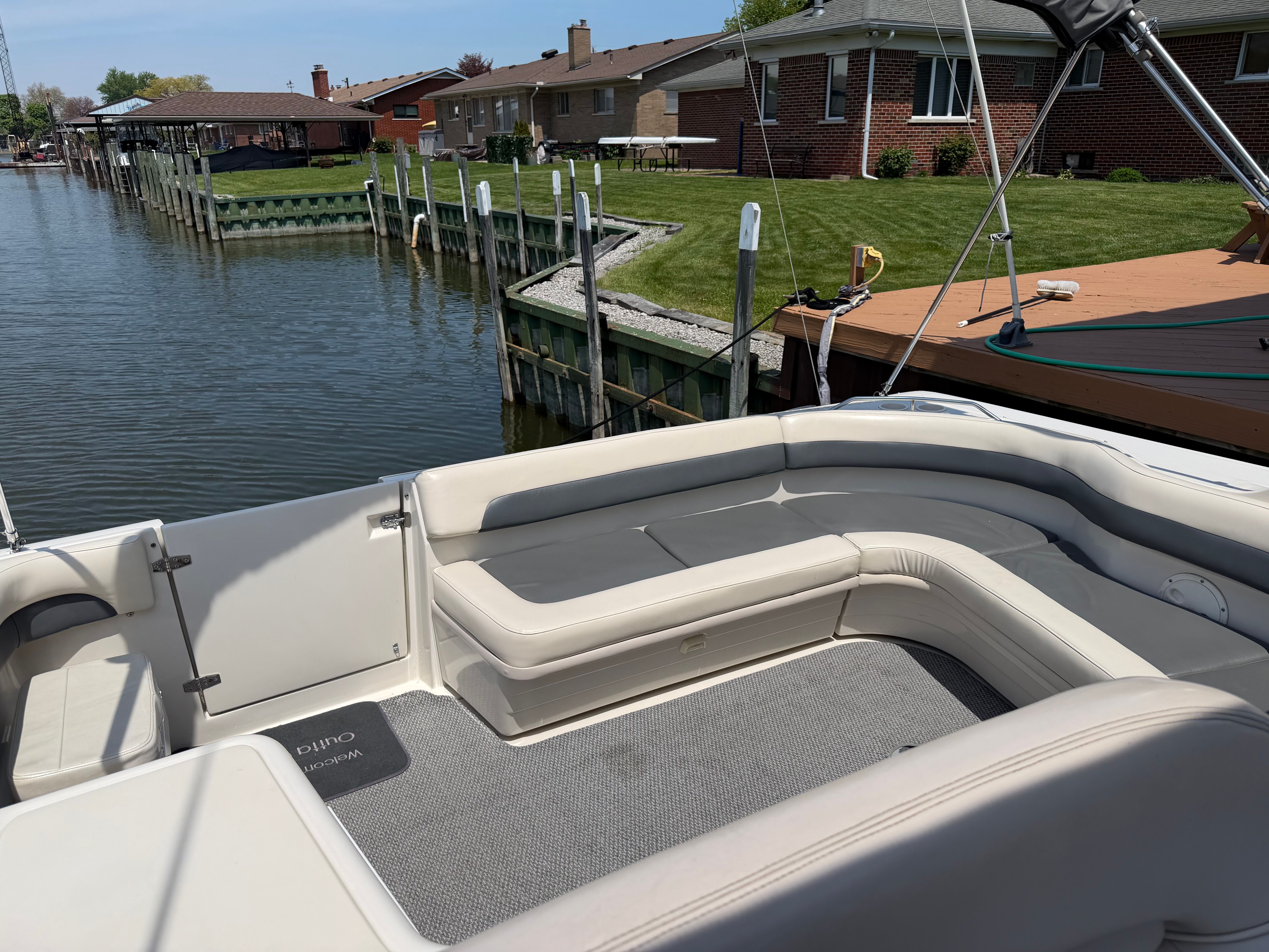 Regal Commodore 1997 boat at dock with seating area.
