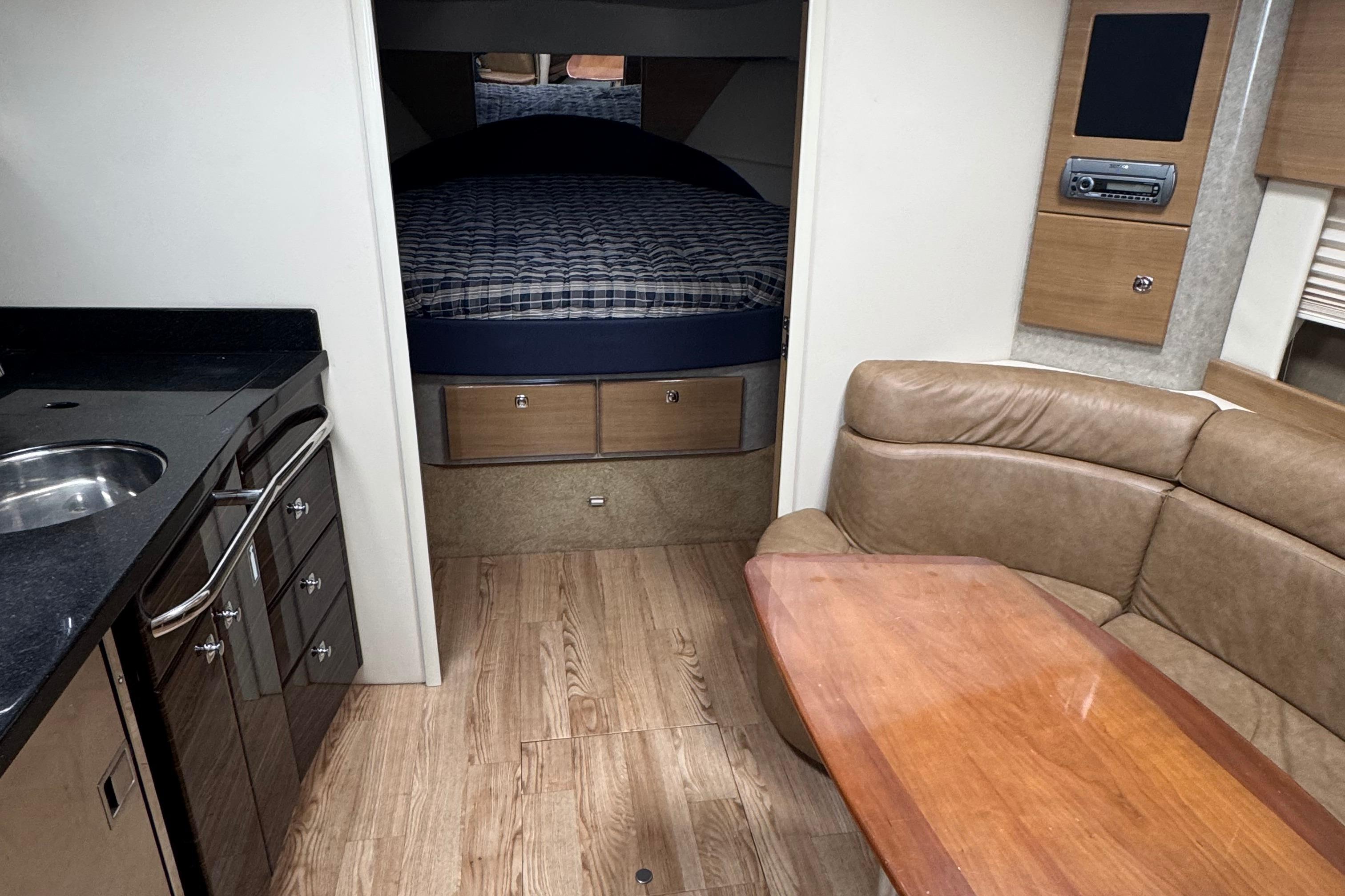 2011 Formula 37 Performance Cruiser interior with kitchen, seating, and bed.