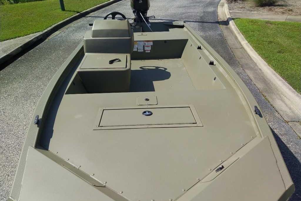 2026 Tracker Grizzly 1648 SC boat on a paved road, showcasing its spacious deck.