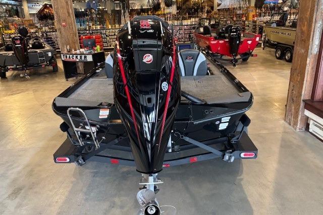 2025 Ranger ALPHA 208 boat displayed in showroom, rear view with motor and trailer.