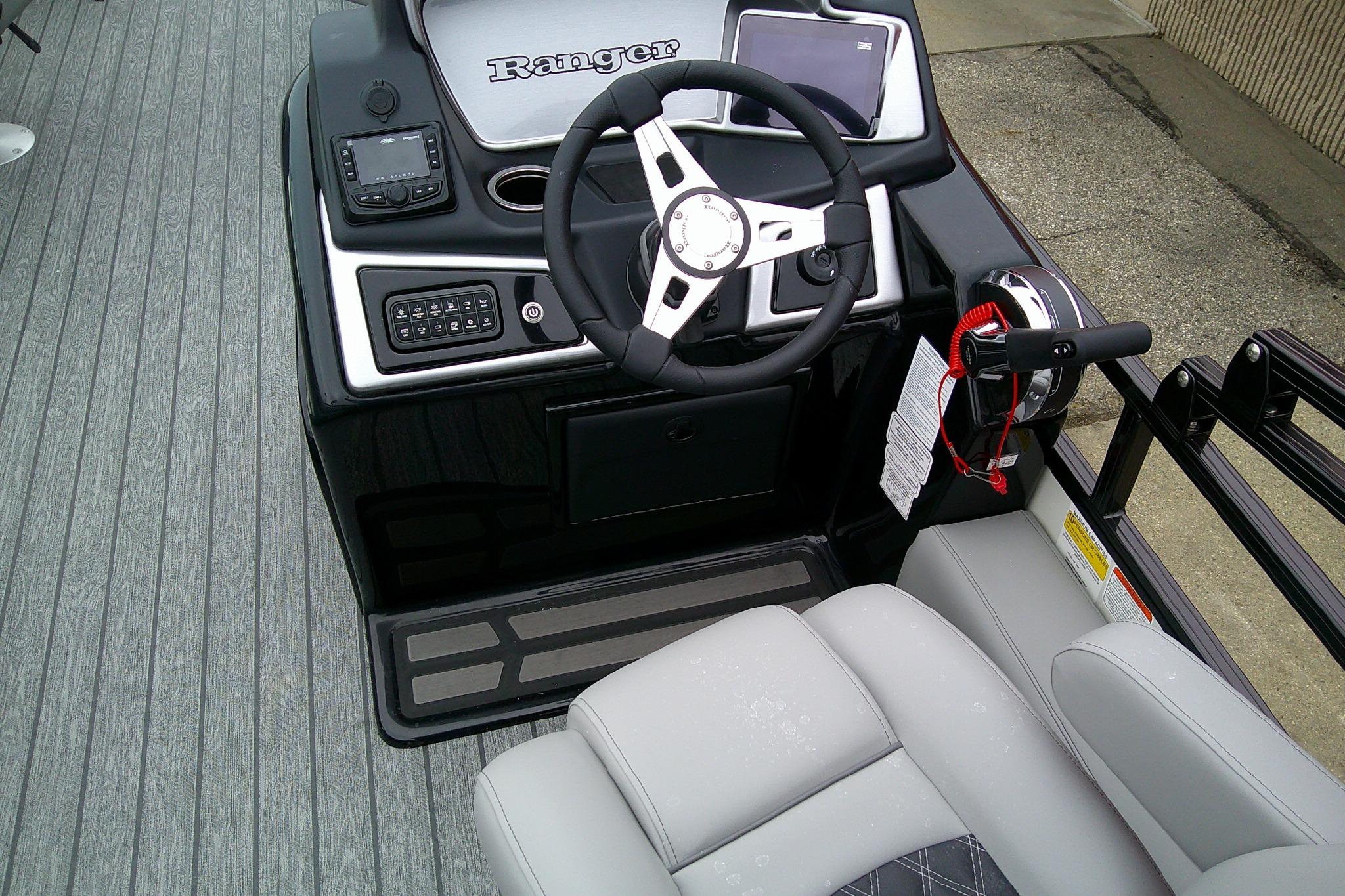 2026 Ranger 220F boat cockpit with steering wheel, controls, and seating.