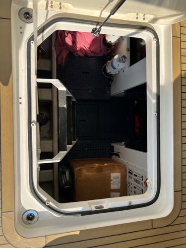 Engine compartment of a 2009 Ovation 52 yacht with storage and equipment.