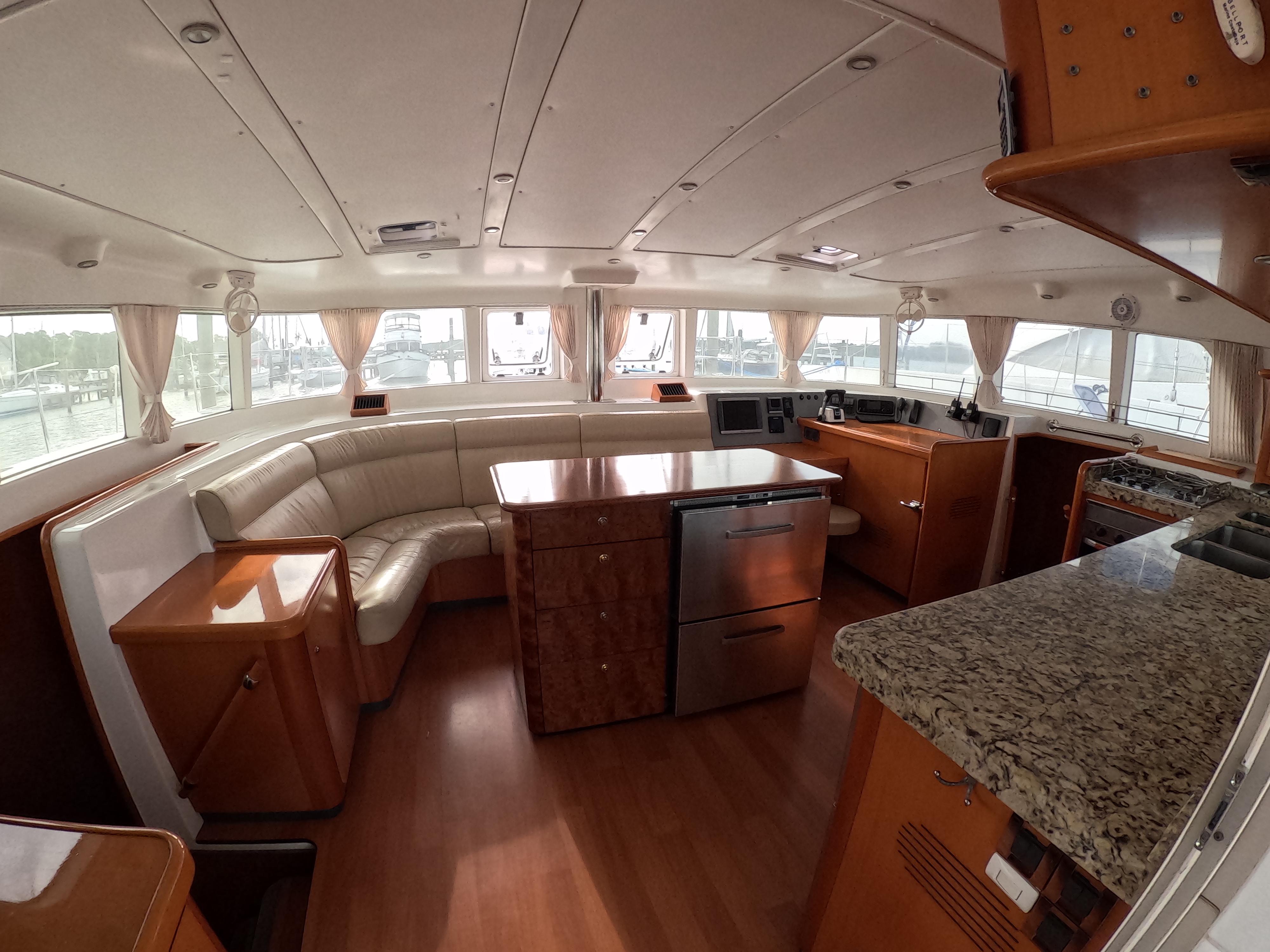 Luxurious interior of a 2006 Lagoon 440 catamaran with modern kitchen and seating area.