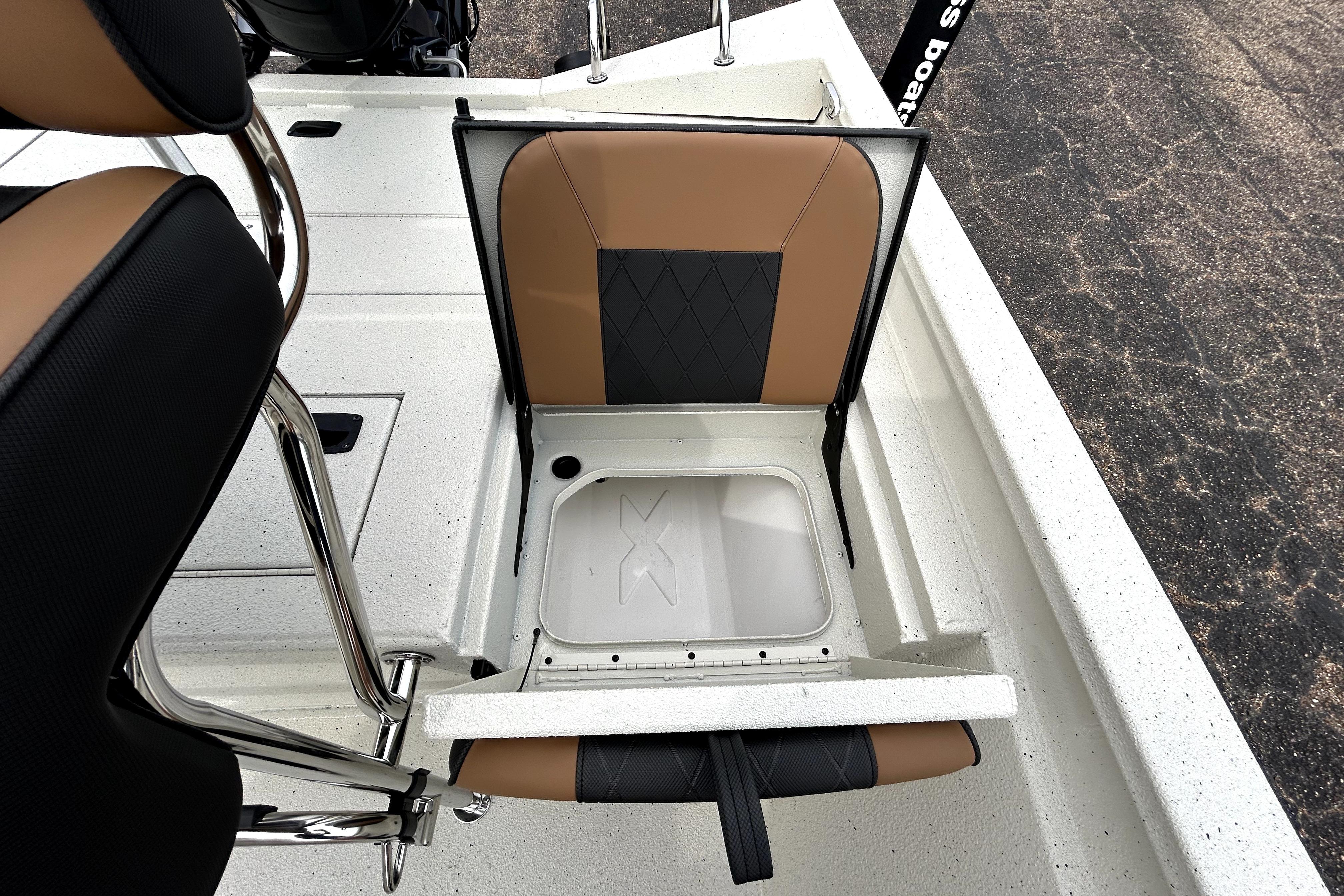 2026 Xpress H20B Bay boat seat with storage compartment open.