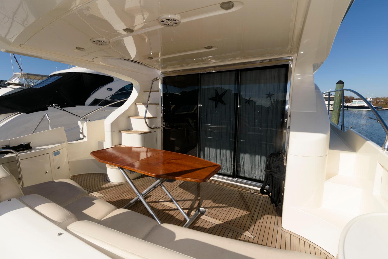 2005 Azimut 50 Flybridge yacht deck with table and seating area.