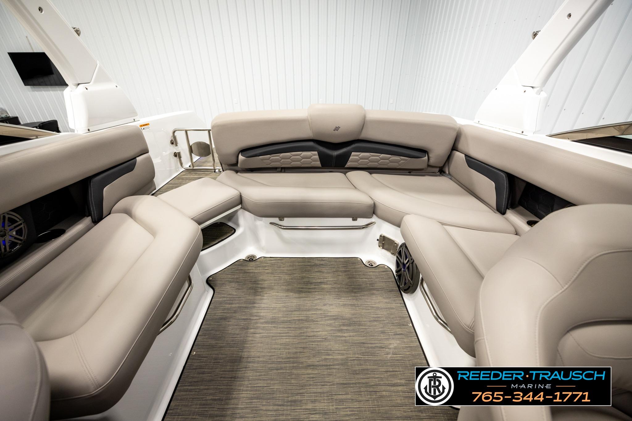 2024 FOURWINNS HD5 Surf boat interior with beige seating and modern design.