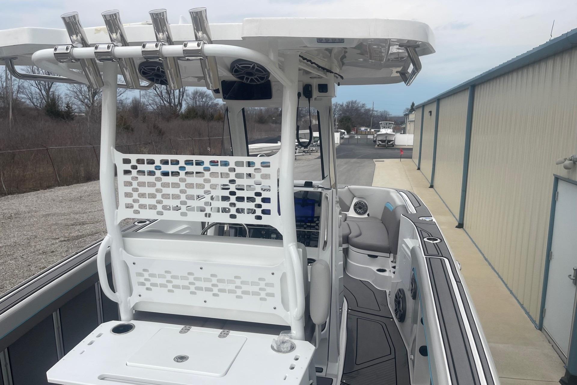 2025 Hurricane Center Console 24 OB boat with modern seating and fishing rod holders.