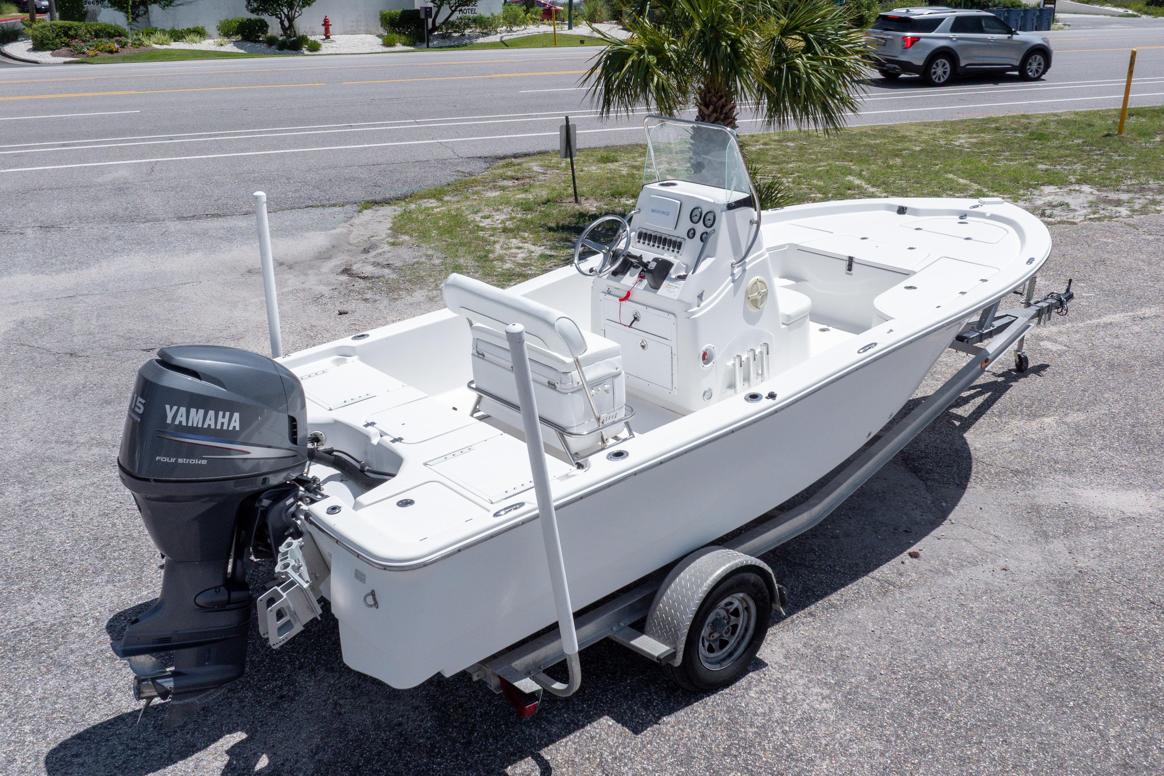2011 Sea Fox 200XT boat on trailer with Yamaha outboard motor, parked near road.