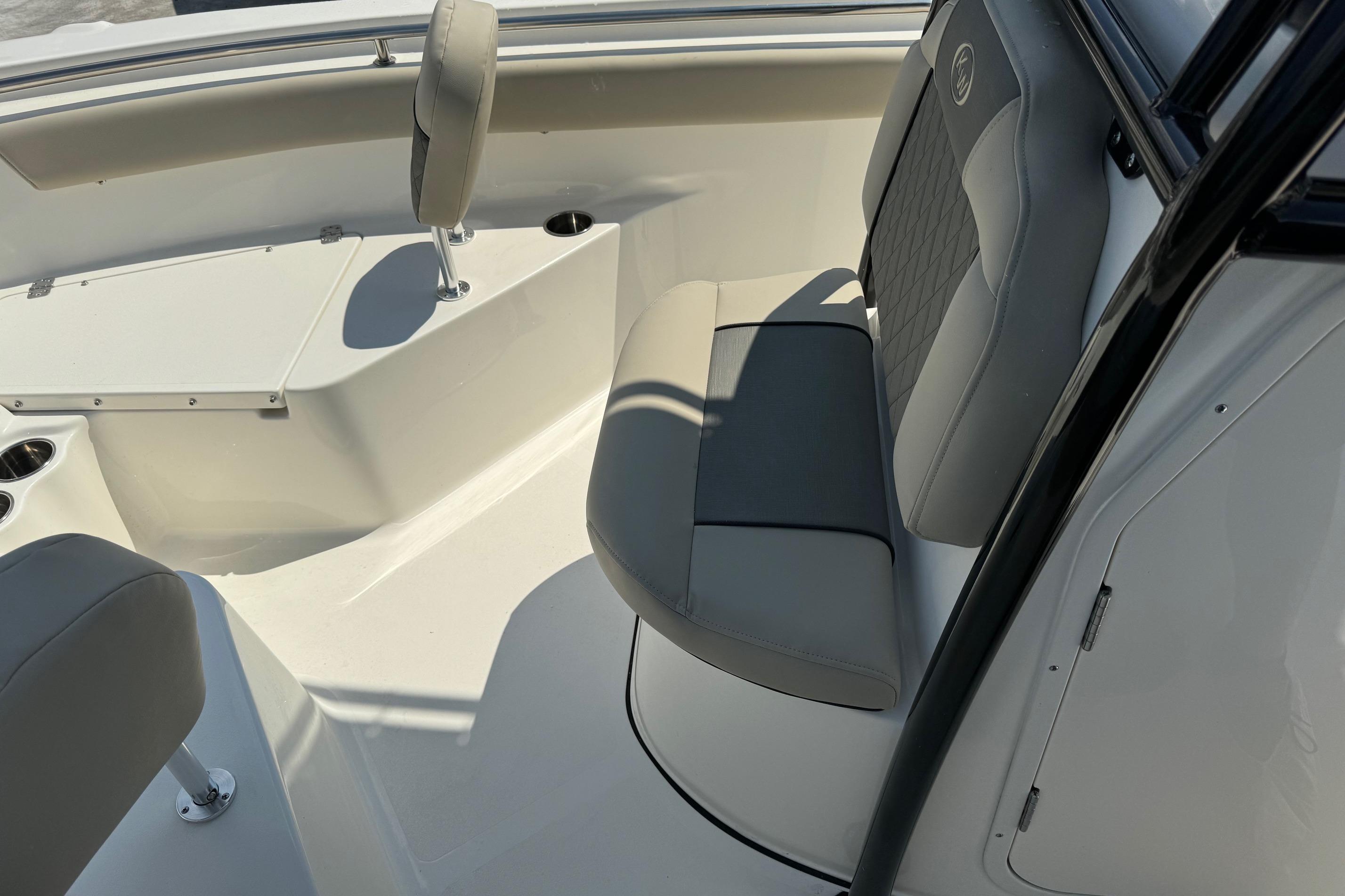 2025 Key West 203 FS boat interior with cushioned seating and cup holders.