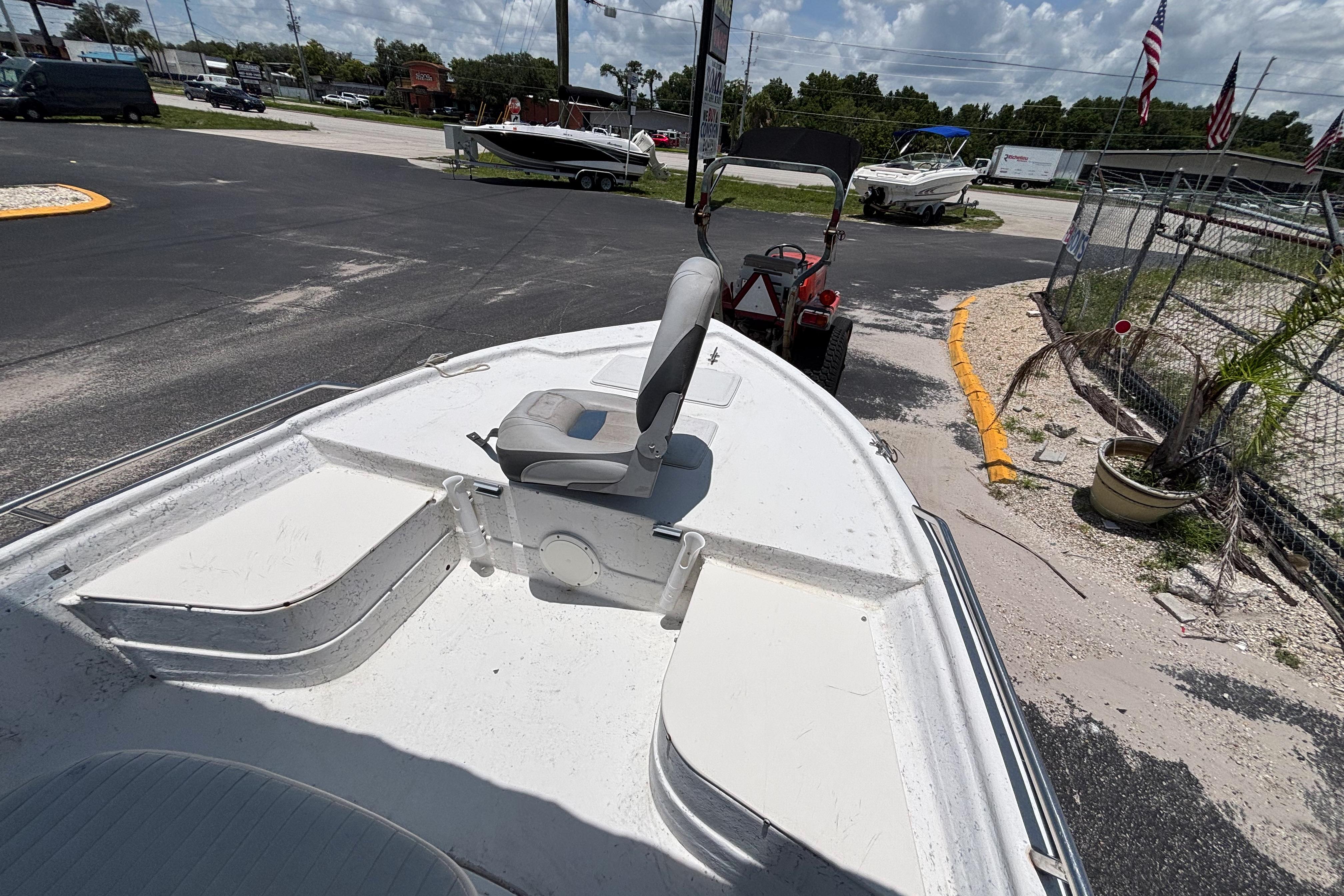 Bow view of a 2000 VIP 1880 BAY STEALTH boat in a parking lot.