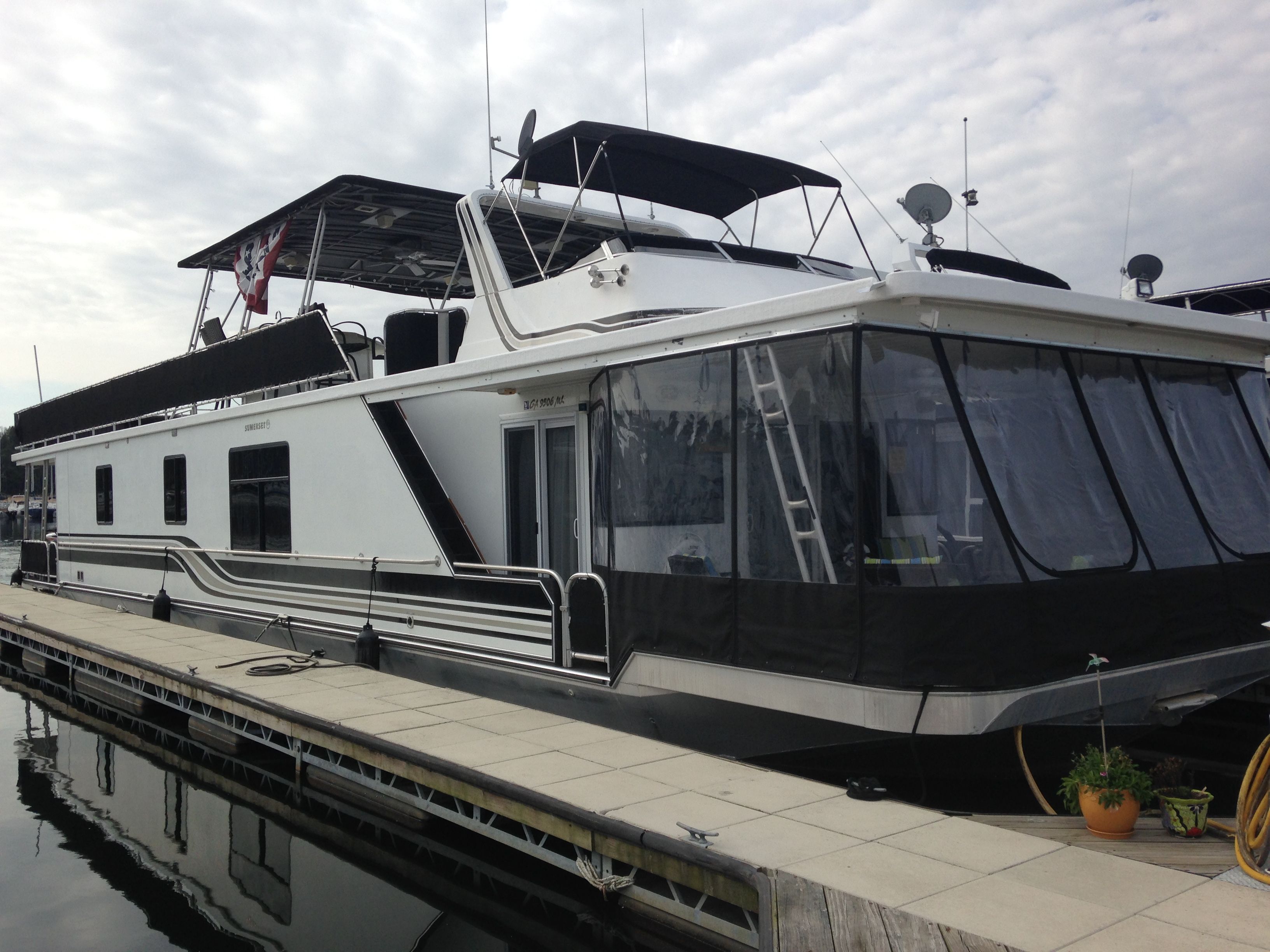 2001 Sumerset houseboat docked, featuring modern design.