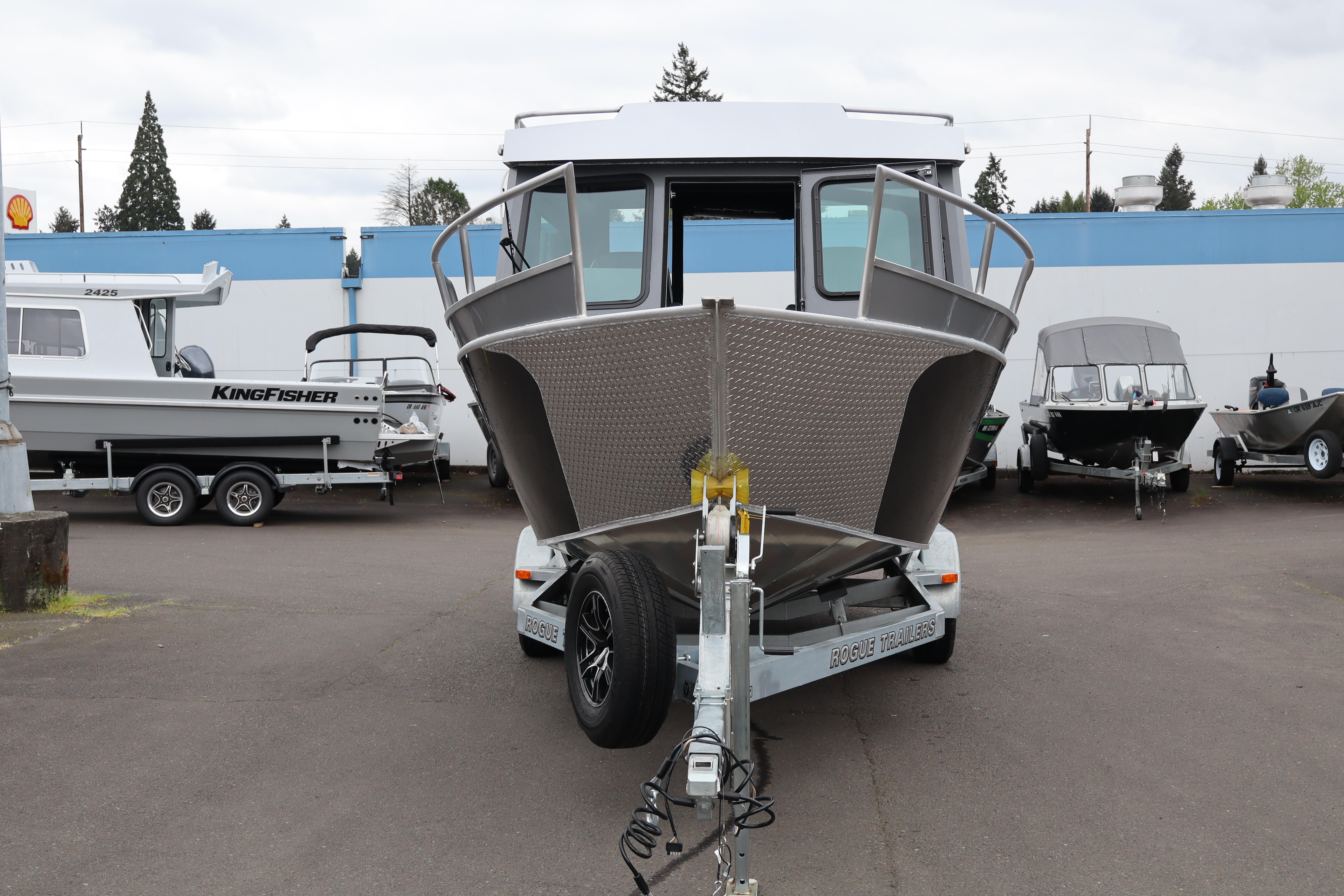 2026 Alumaweld Horizon 24 boat on trailer in dealership lot.