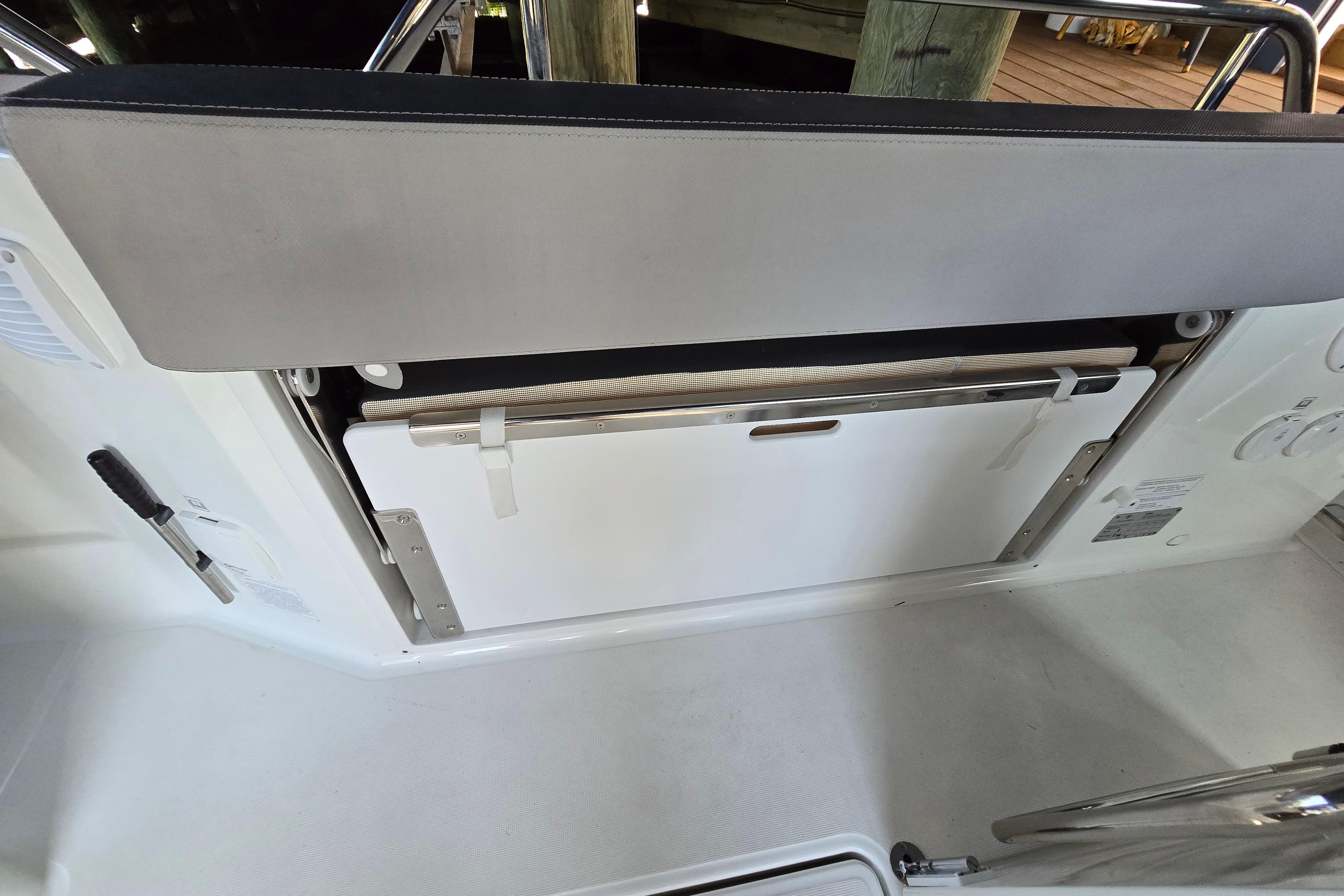 A seating area on a Jeanneau NC Sport 895 boat with storage underneath.