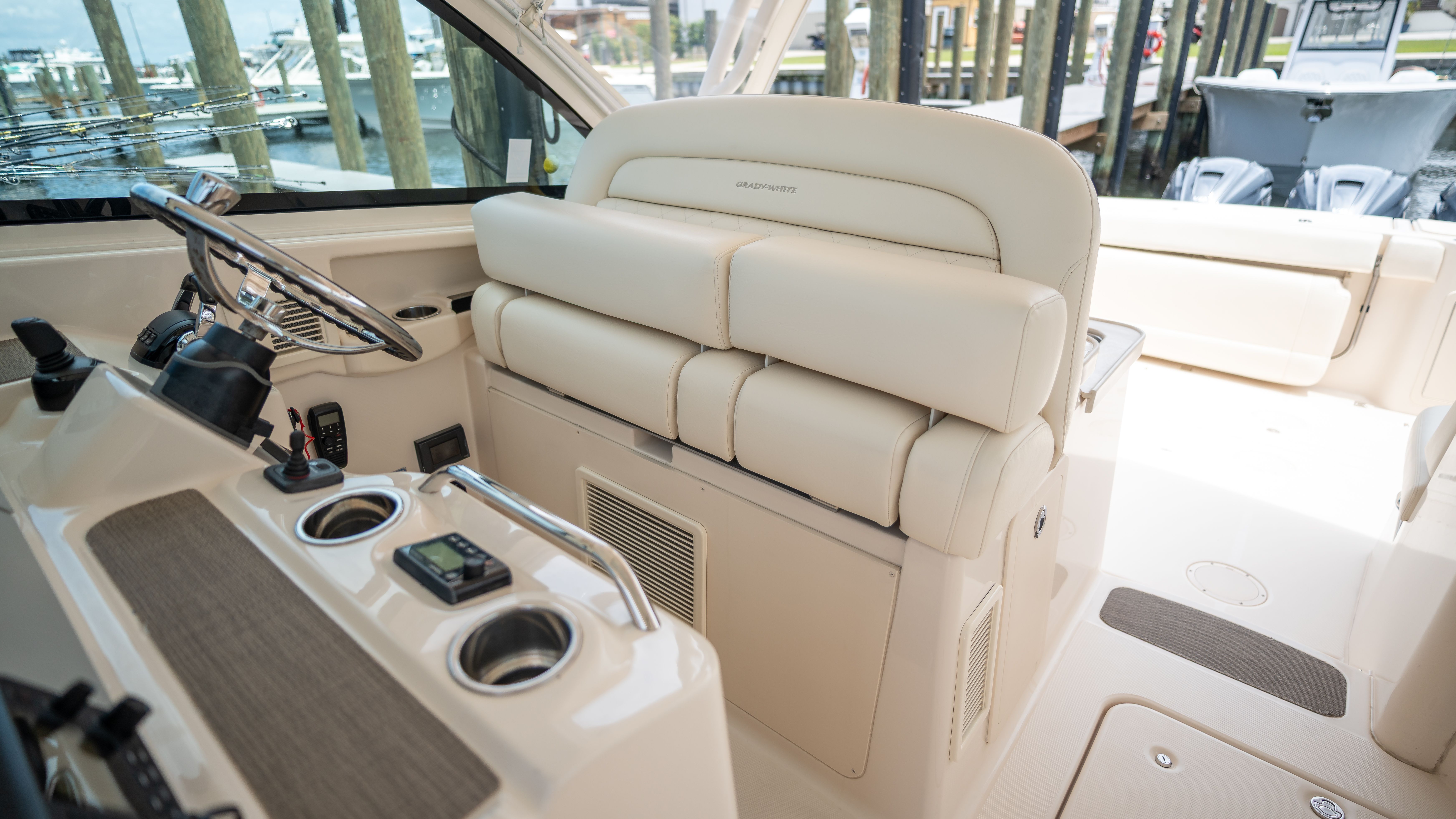 Interior view of a Grady-White 375 Freedom boat with beige seating area and helm console.
