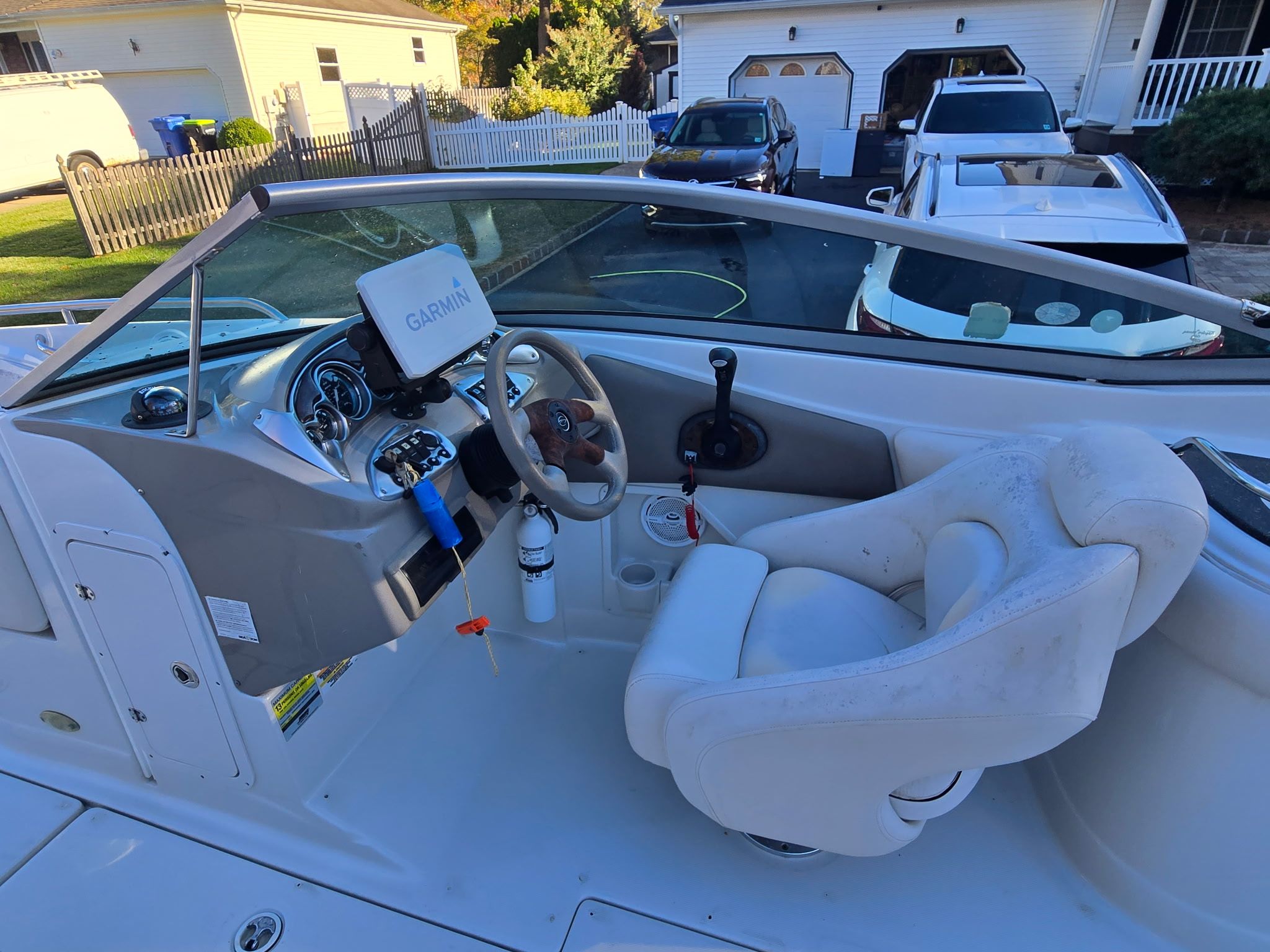 The image shows the cockpit of a 2005 Crownline 240 EX boat with a Garmin navigation system.