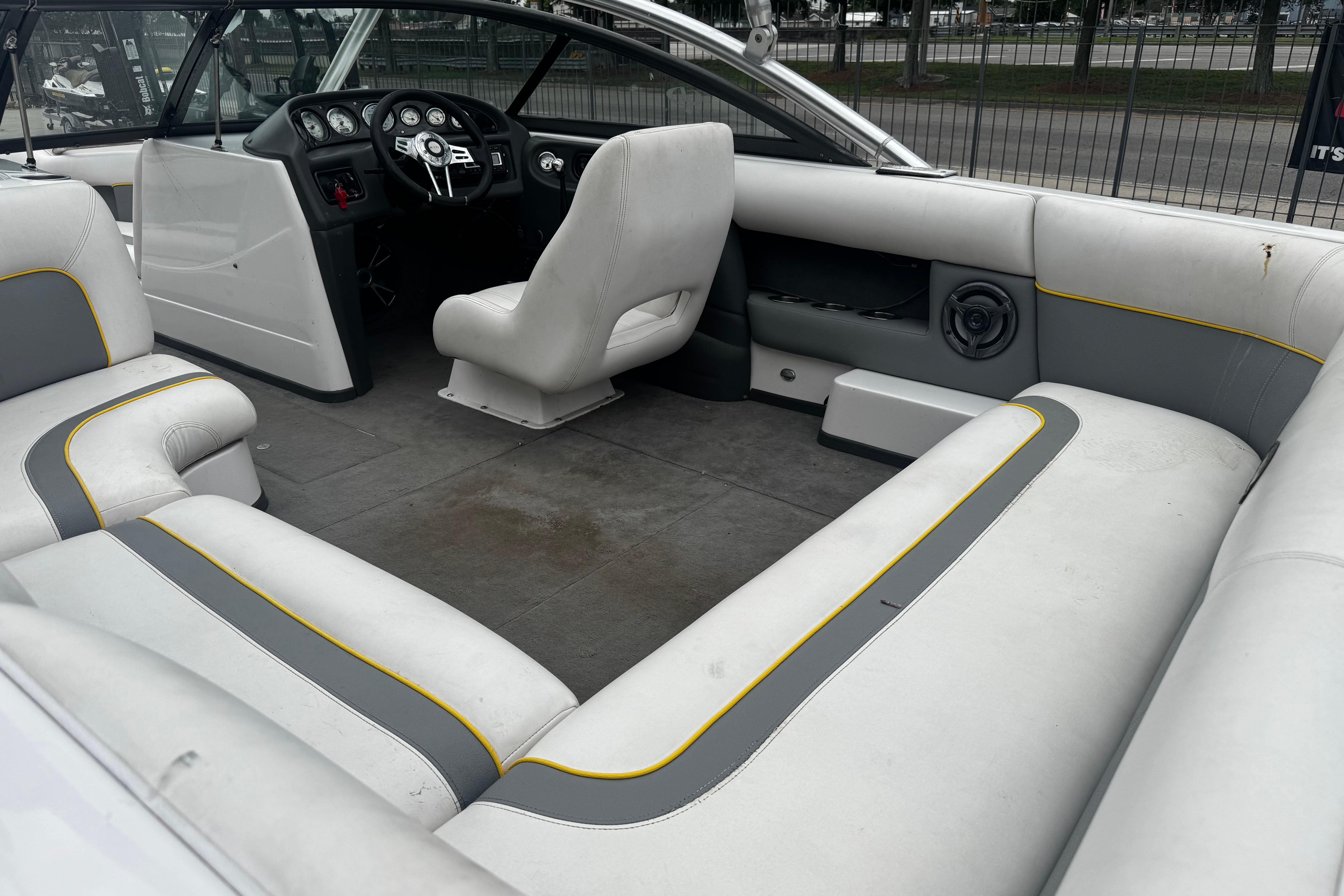 2006 Supra Launch 22 SSV boat interior with gray and white seating, yellow accents.