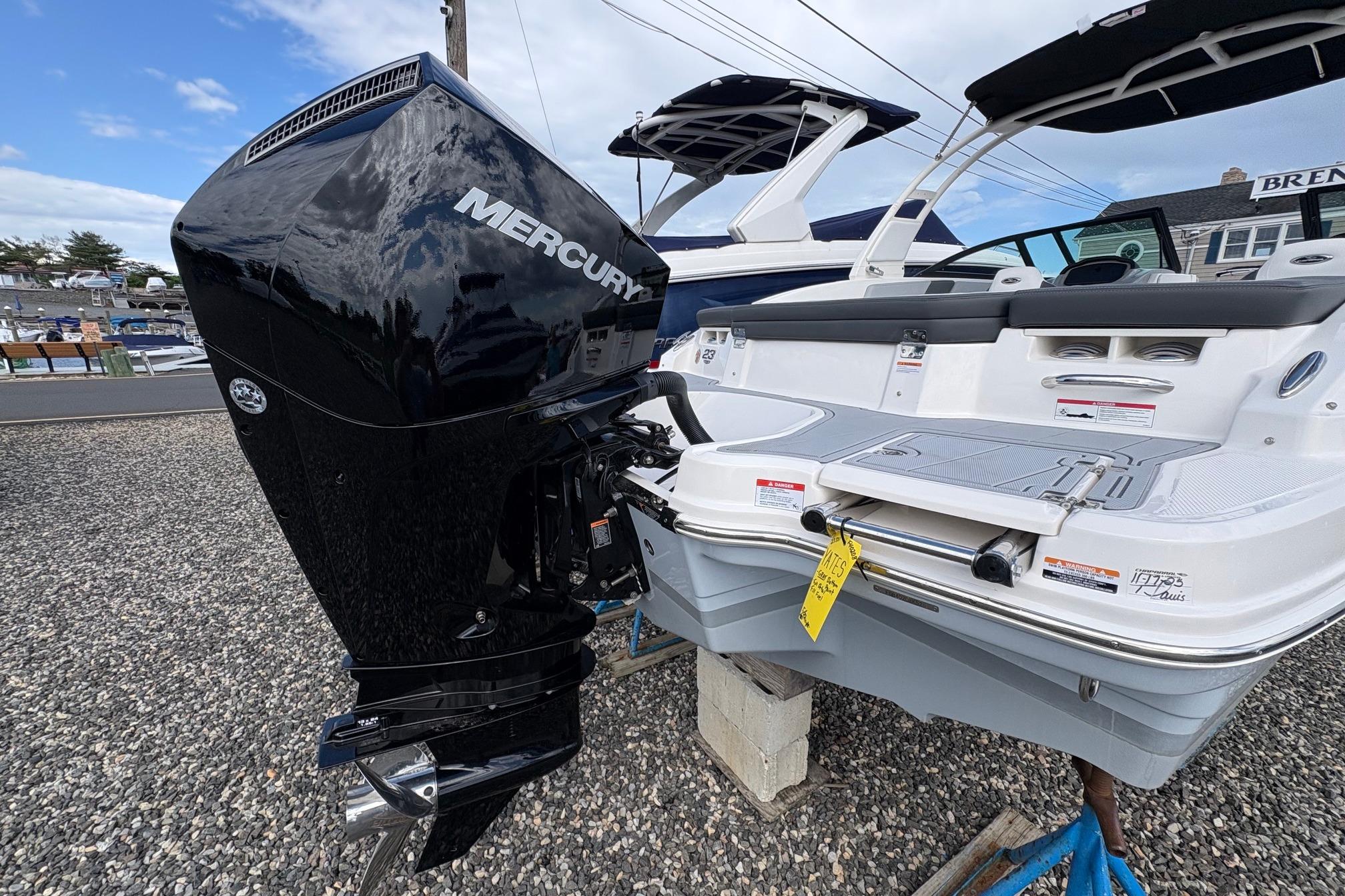 2026 Chaparral 23 SSi OB boat with Mercury outboard motor, displayed outdoors.