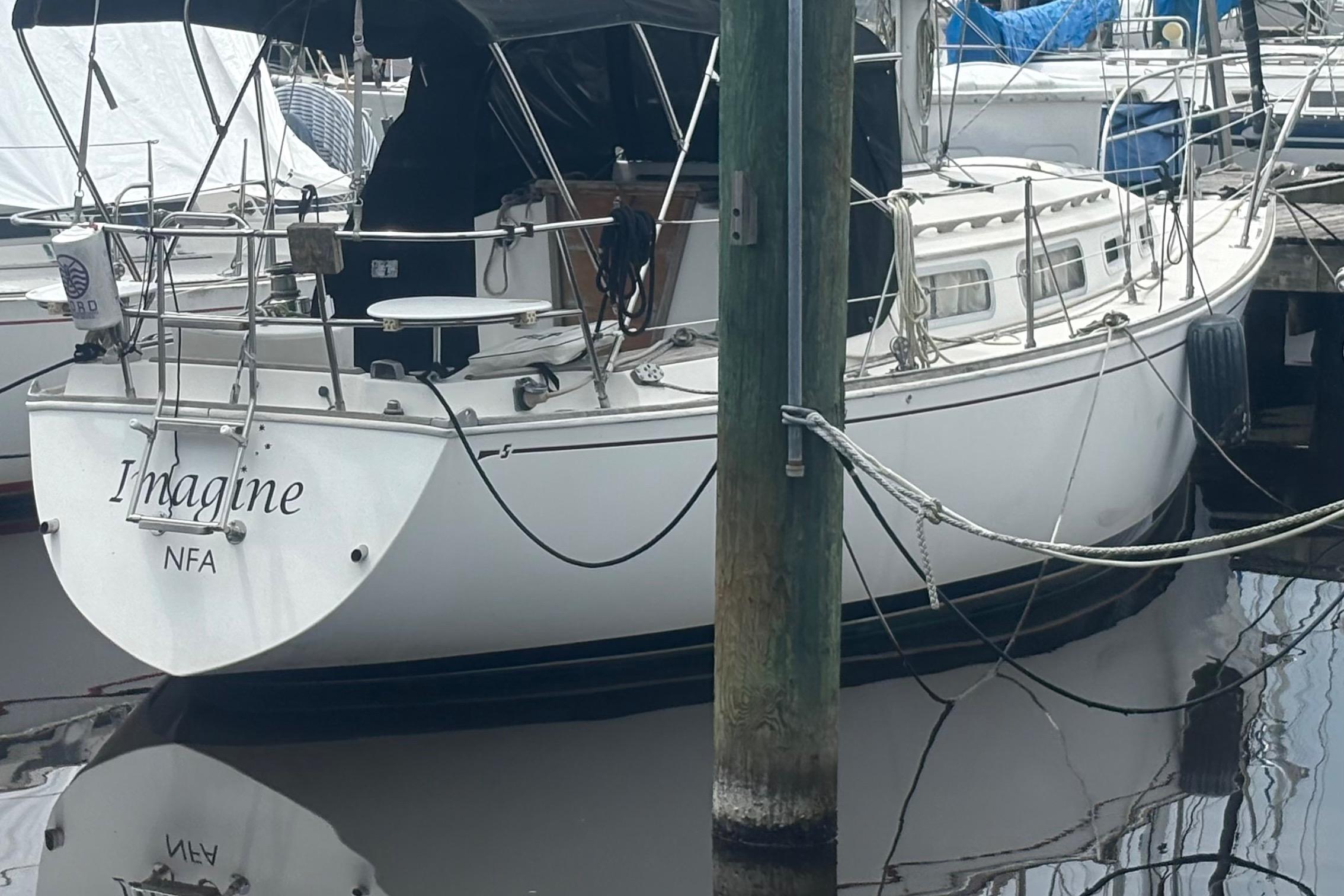 1981 Sabre 31 sailboat named "Imagine" docked at a marina.