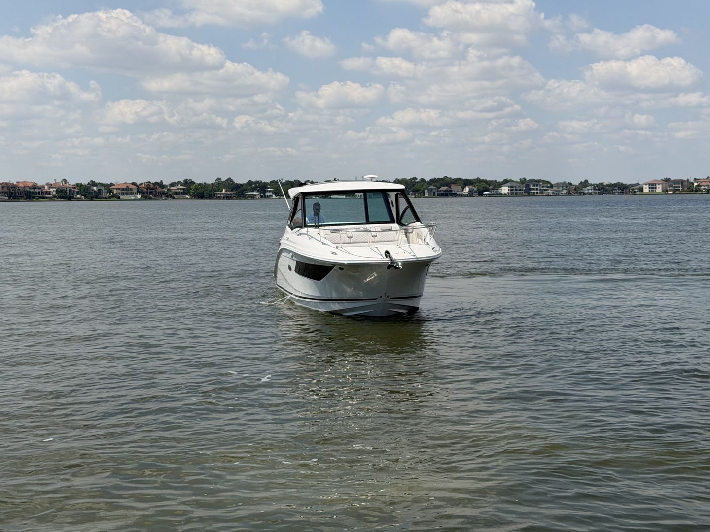 2026 Sea Ray Sundancer 320 Outboard on calm waters.