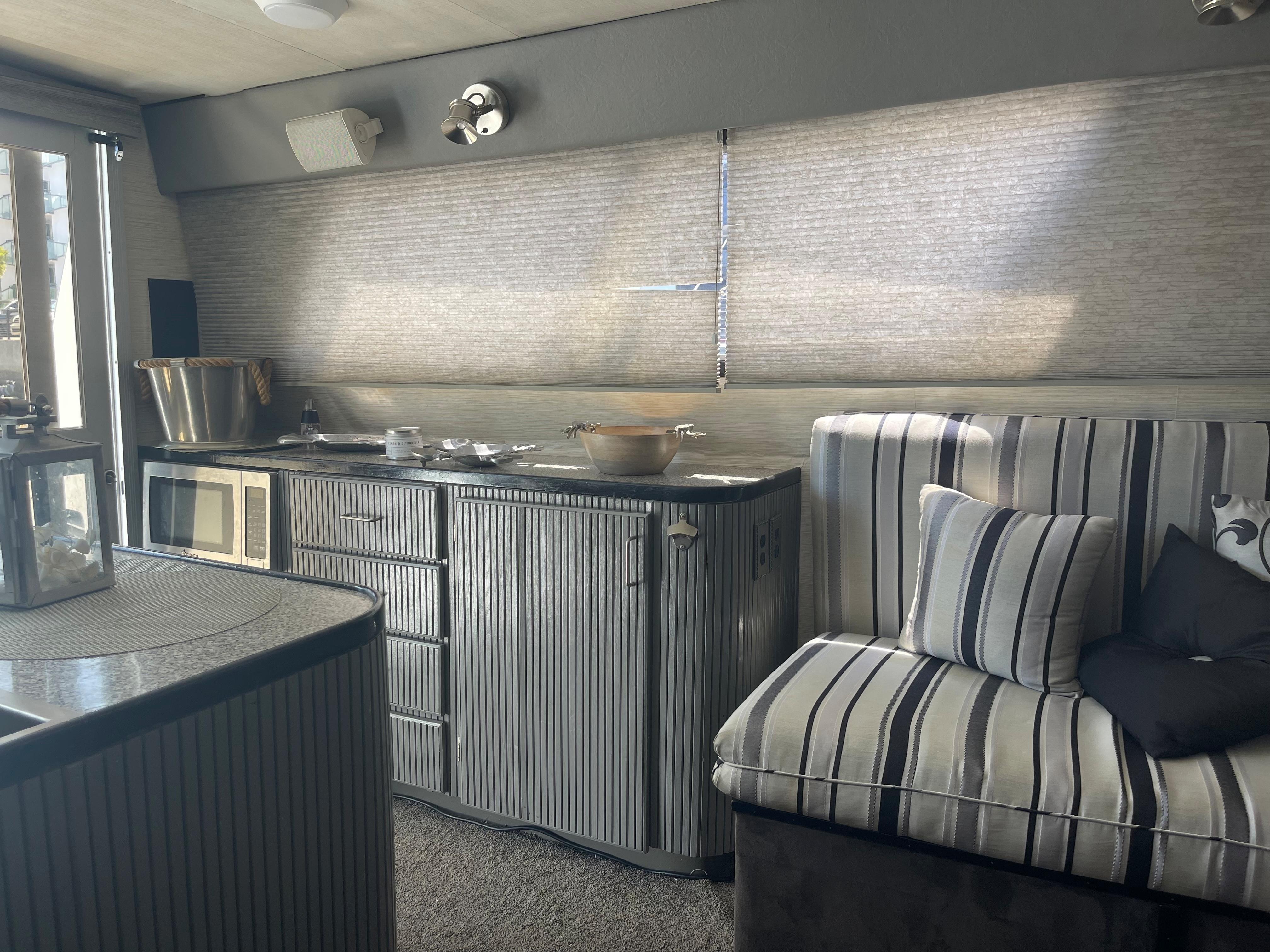 Interior of a 1986 Sea Hawk Sedan with striped seating and kitchenette.