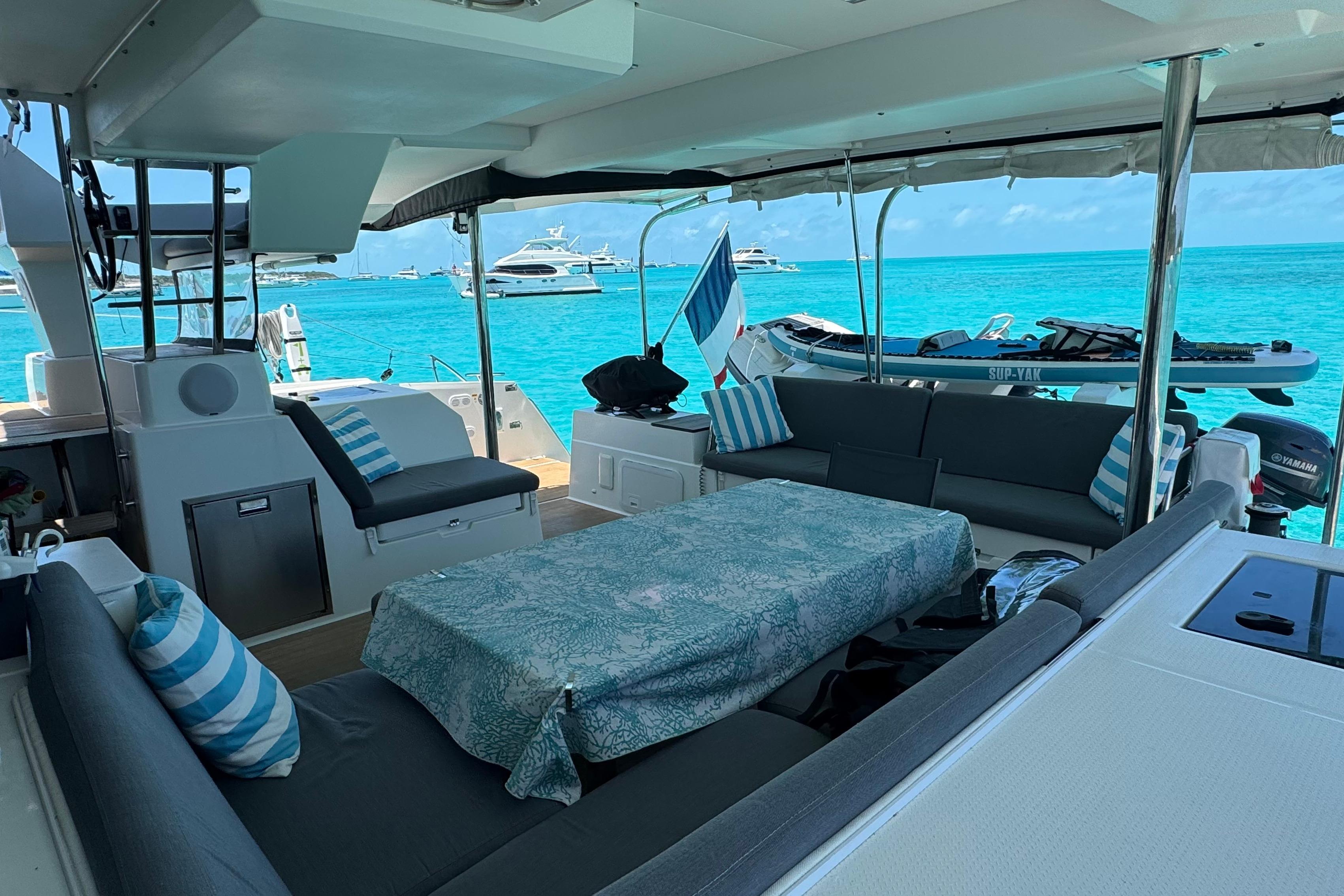 Luxurious 2020 Fountaine Pajot Saona 47 catamaran interior with ocean view and striped cushions.