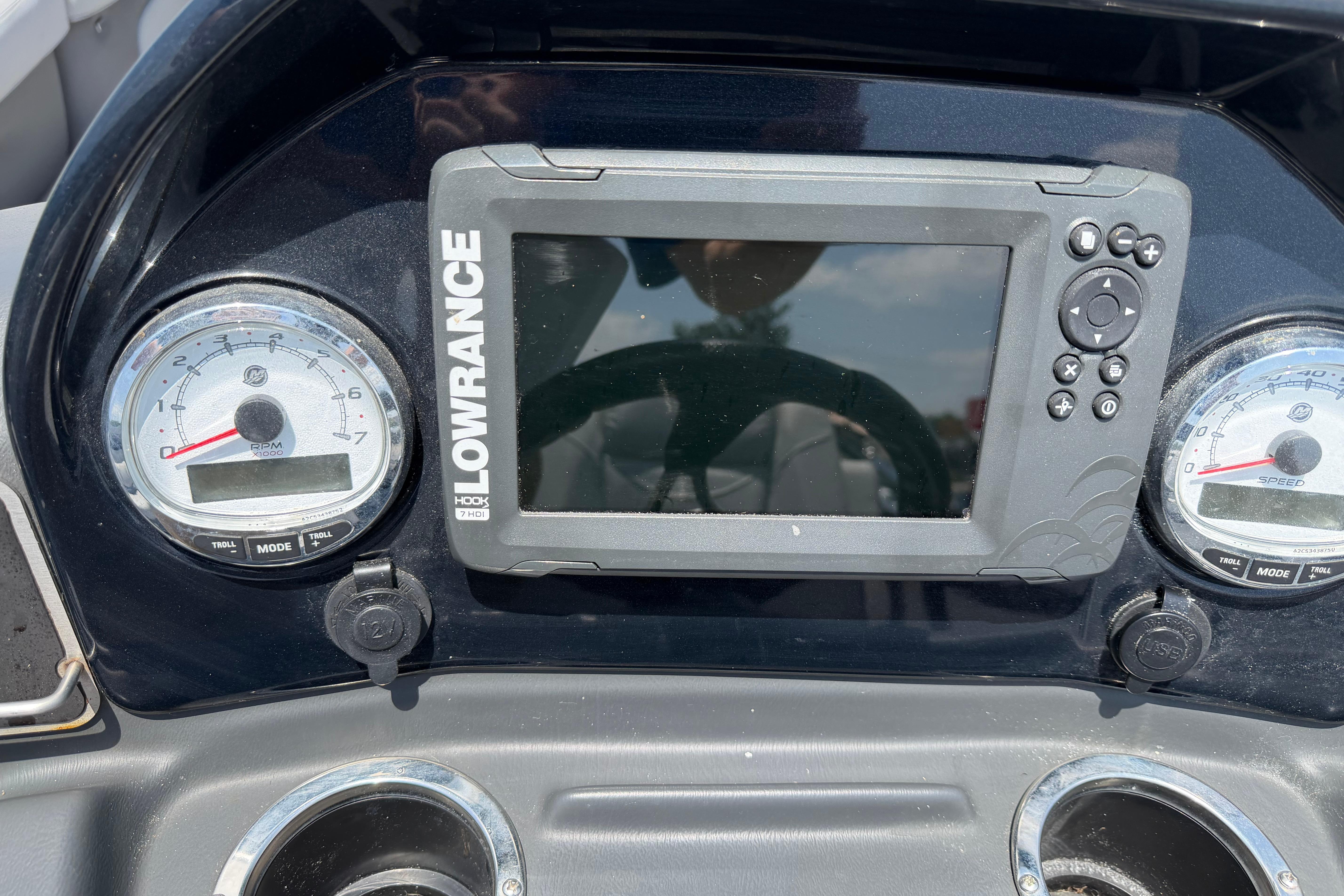 Dashboard of a 2019 Regency 230 DL3 boat featuring Lowrance display and gauges.