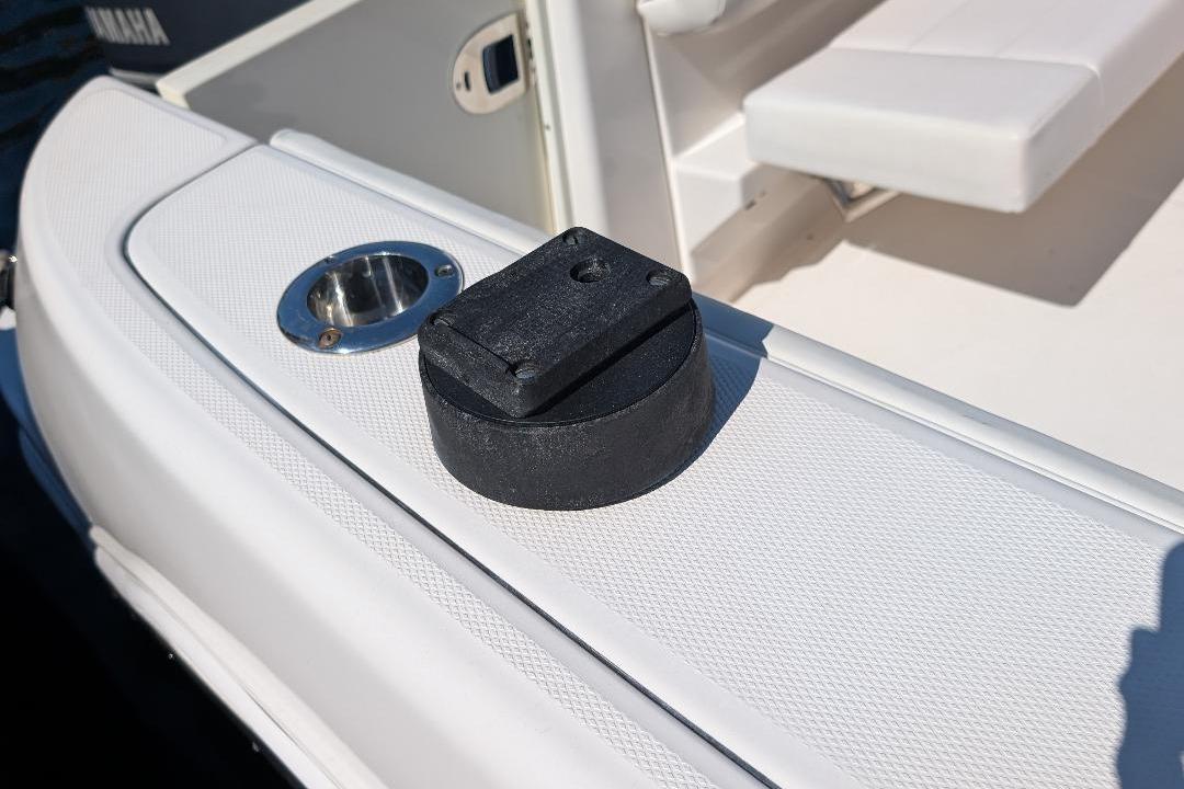 2014 Robalo R305 Walkaround boat deck with rod holder and black accessory.