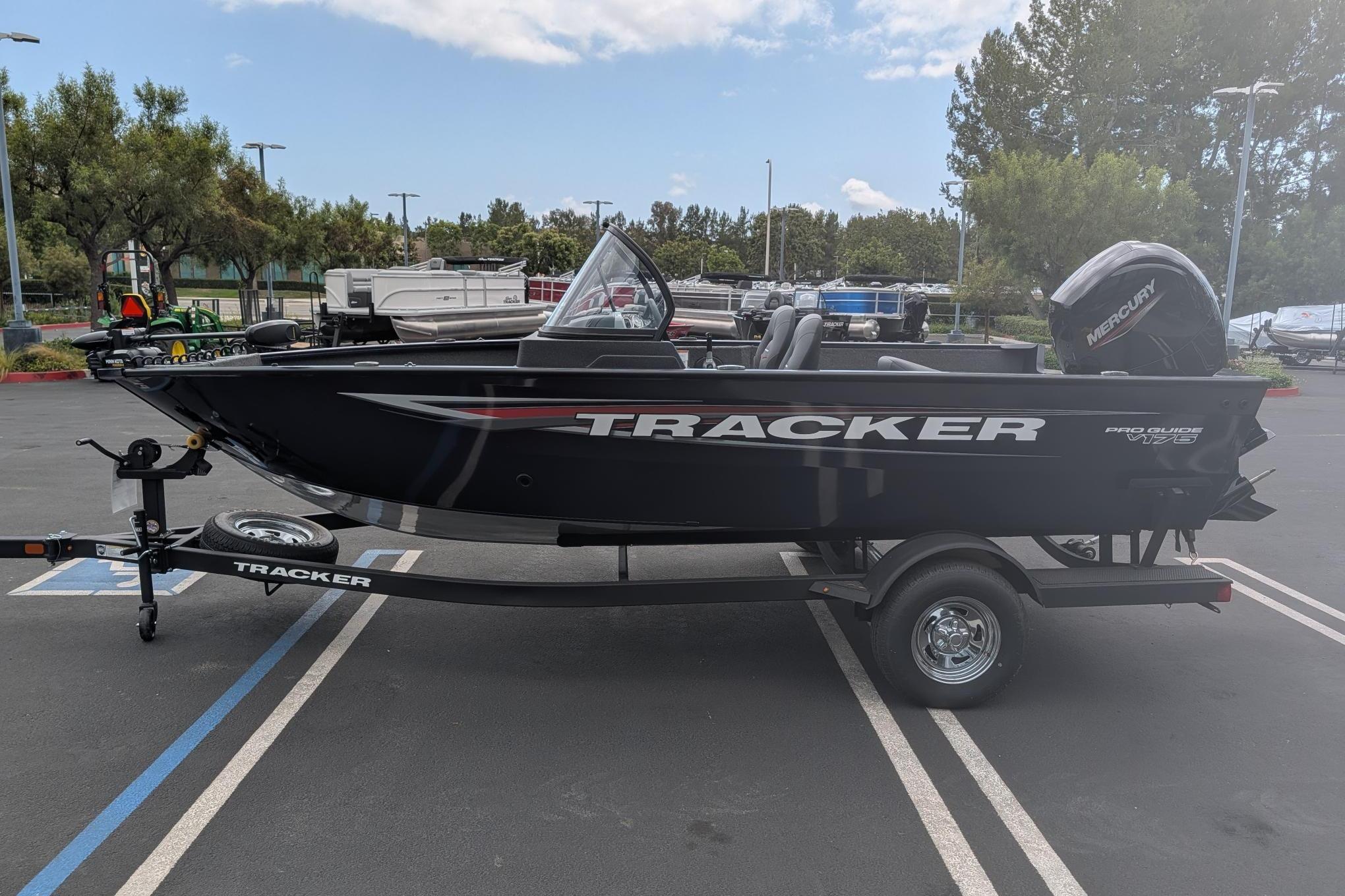 2026 Tracker Pro Guide V-175 WT boat on trailer in parking lot.