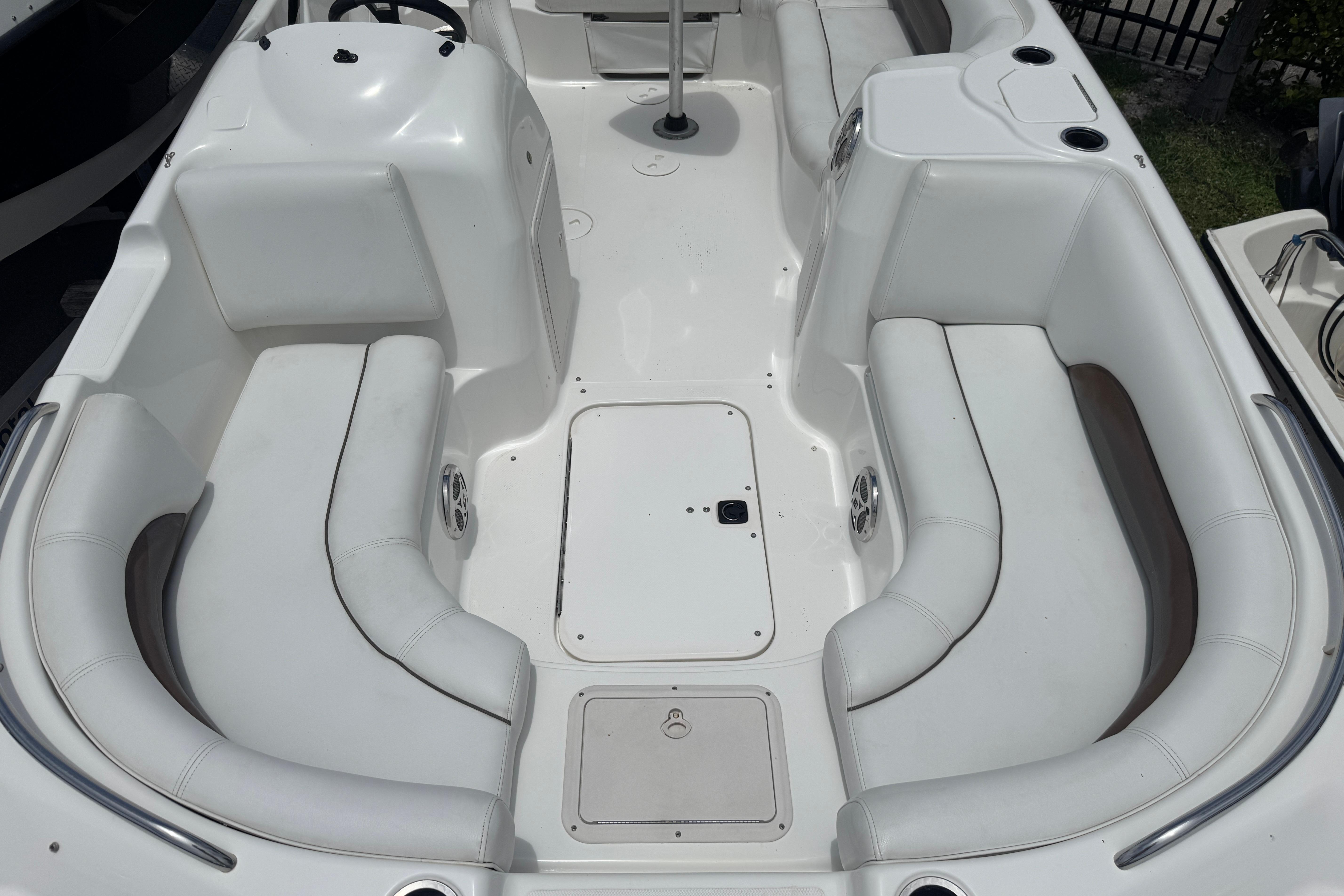 2013 Hurricane SunDeck Sport 188 OB boat interior with white seating and storage compartments.