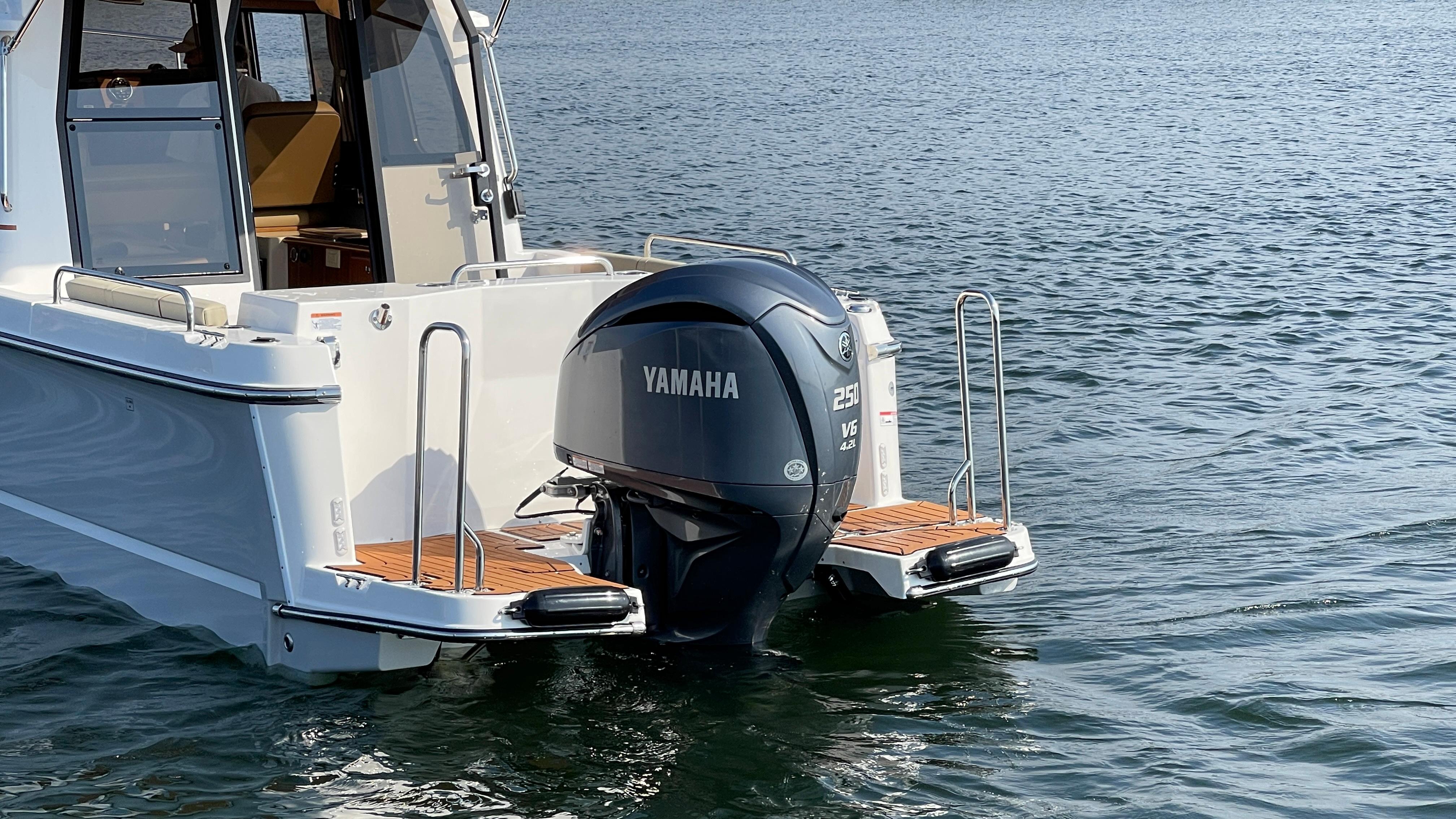 2025 Ranger Tugs R-25 with Yamaha outboard motor on water.