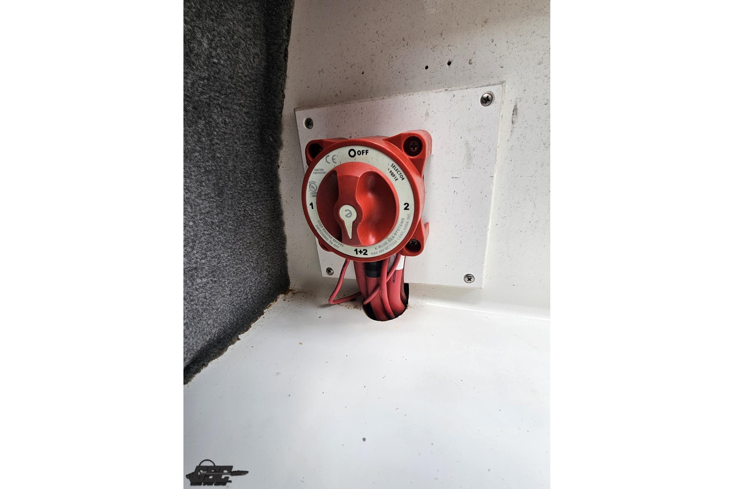 Battery switch in a 2010 Cobalt 232 WSS boat, mounted on a white panel.