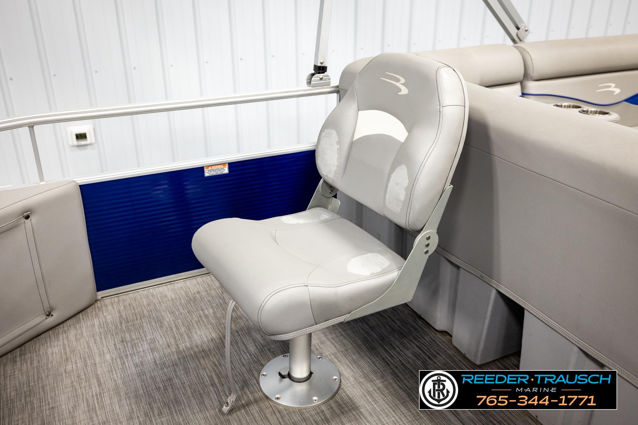2021 Bennington 20 SV boat seat with gray upholstery in a showroom setting.